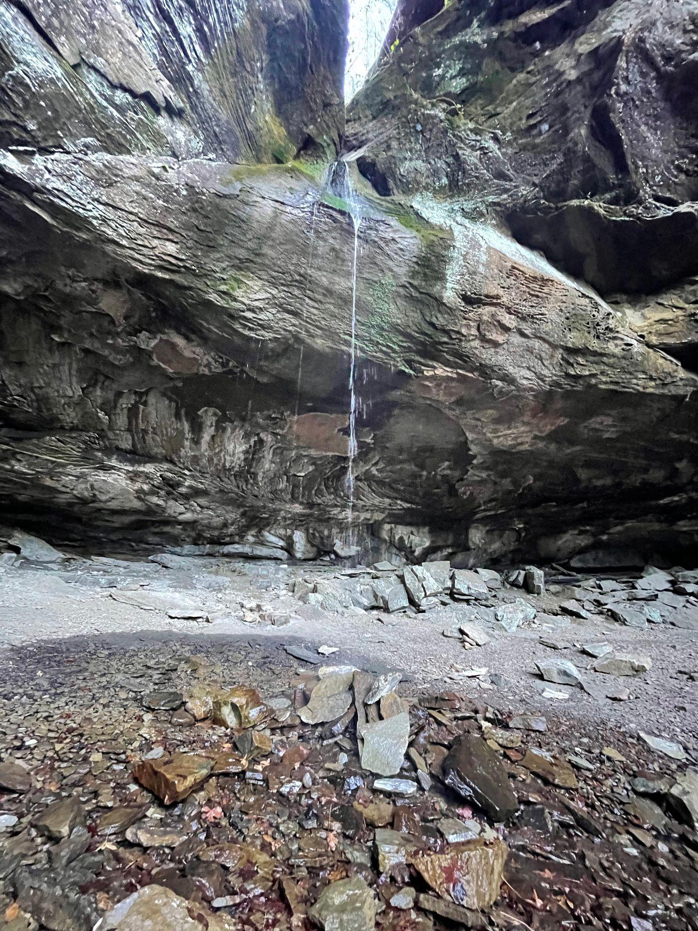 A view of Pam's Grotto with a small pool of water in front.