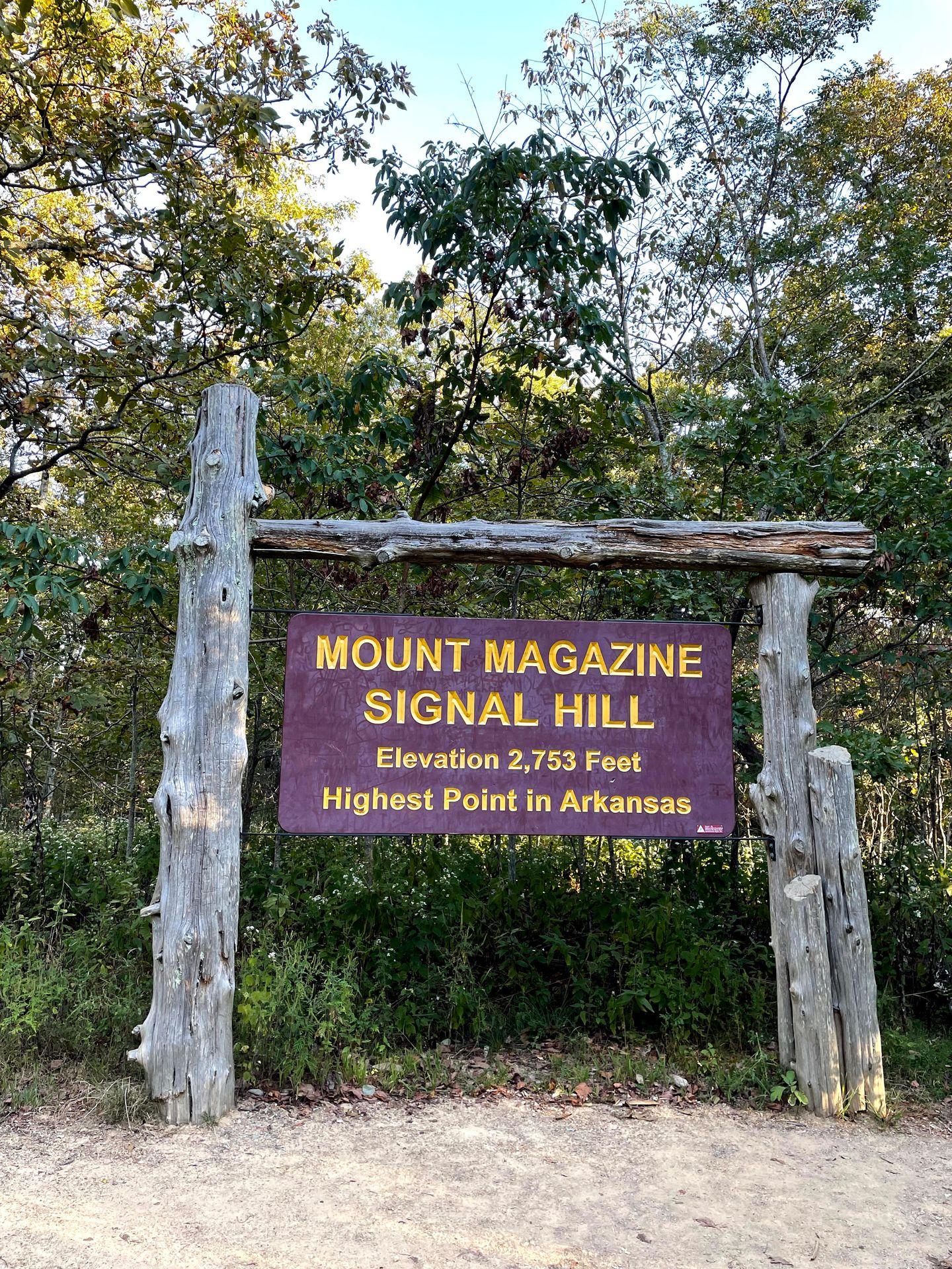 A large sign that reads: Mountain Magazine Signal Hill, Elevation 2,753 feet, Highest Point in Arkansas