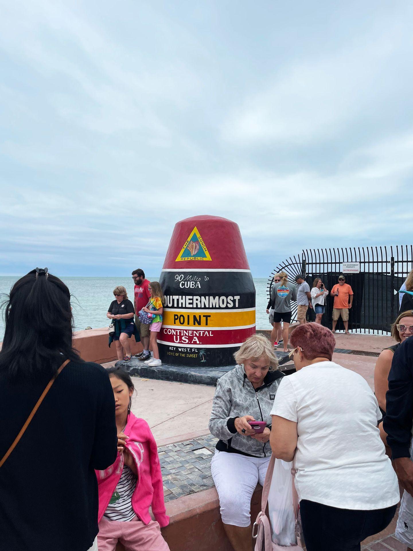 The southernmost buoy in Key West surrounded by a crowd of people