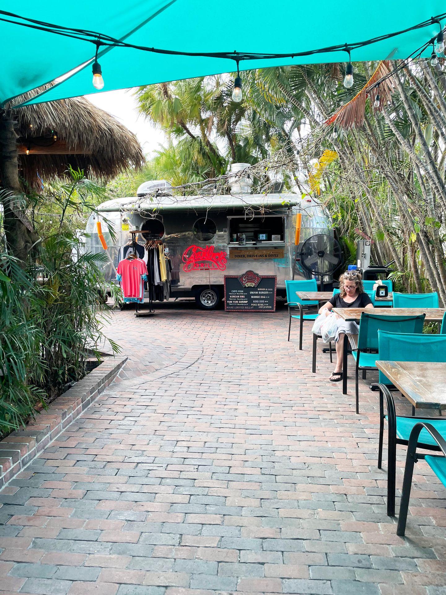 Looking back at a airstream food truck in an outdoor patio area.