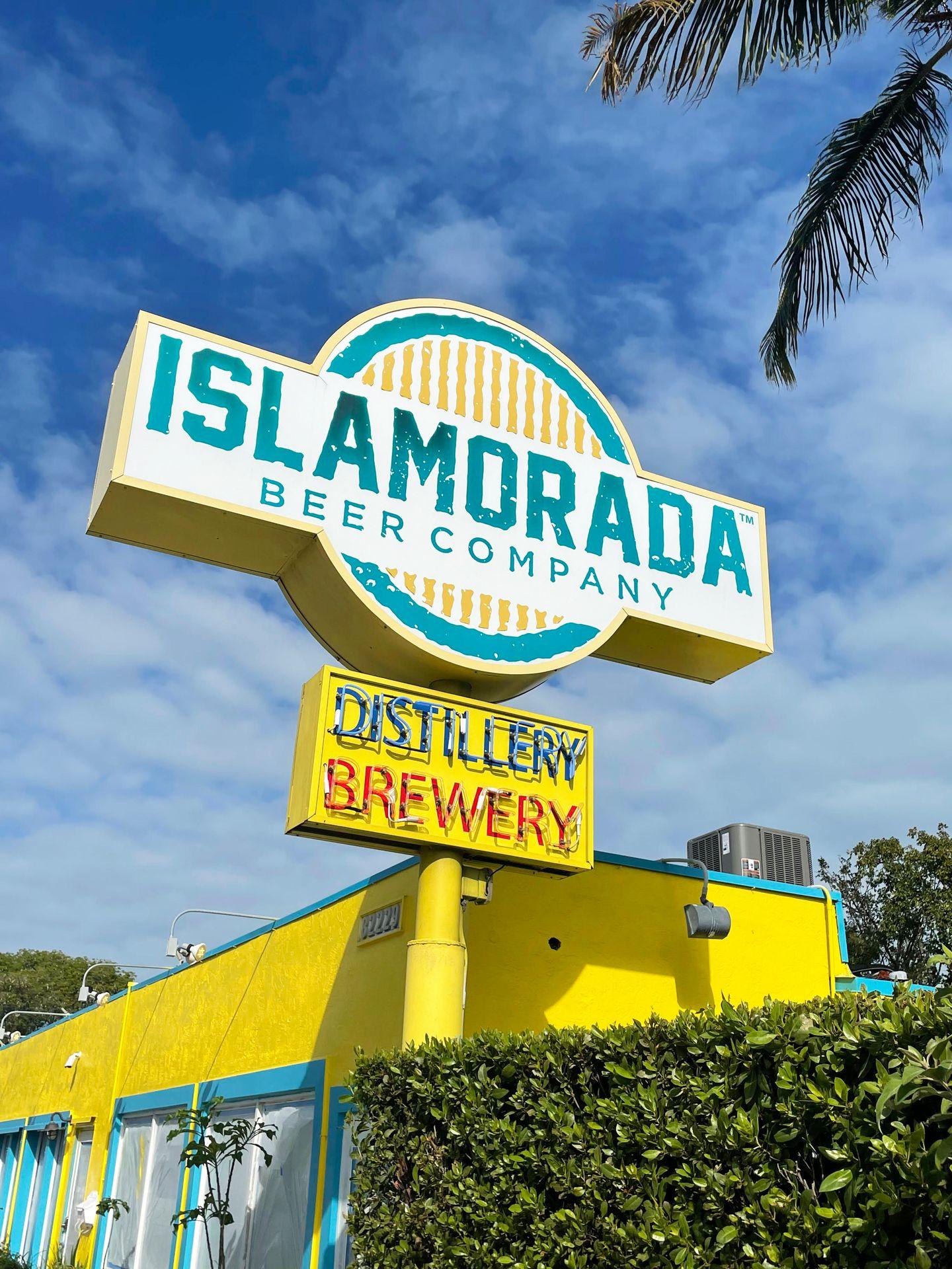 A large yellow and blue Islamorada Brewery and Distillery sign