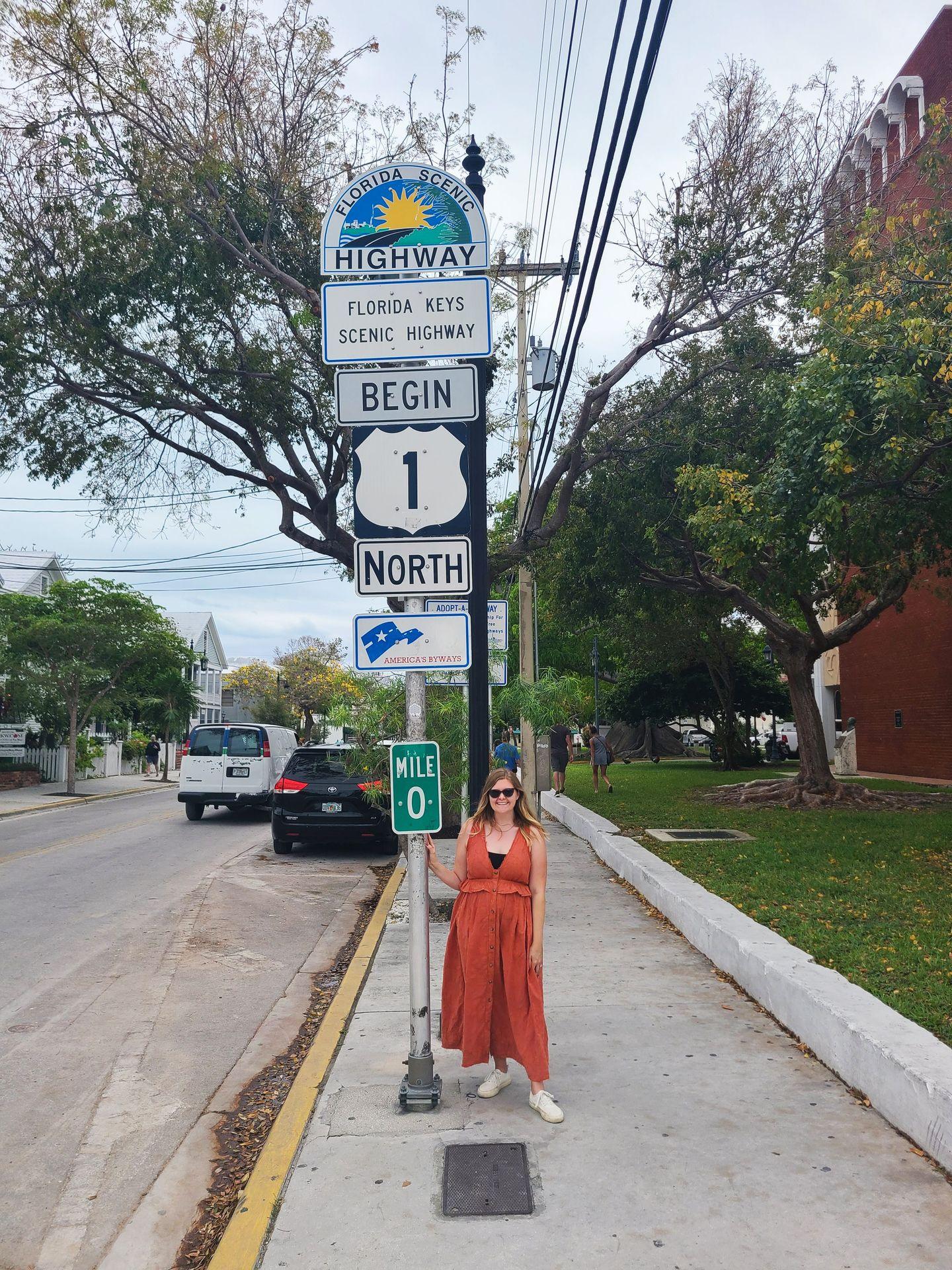 Lydia standing next to the Florida Keys Scenic Highway Mile Zero street sign