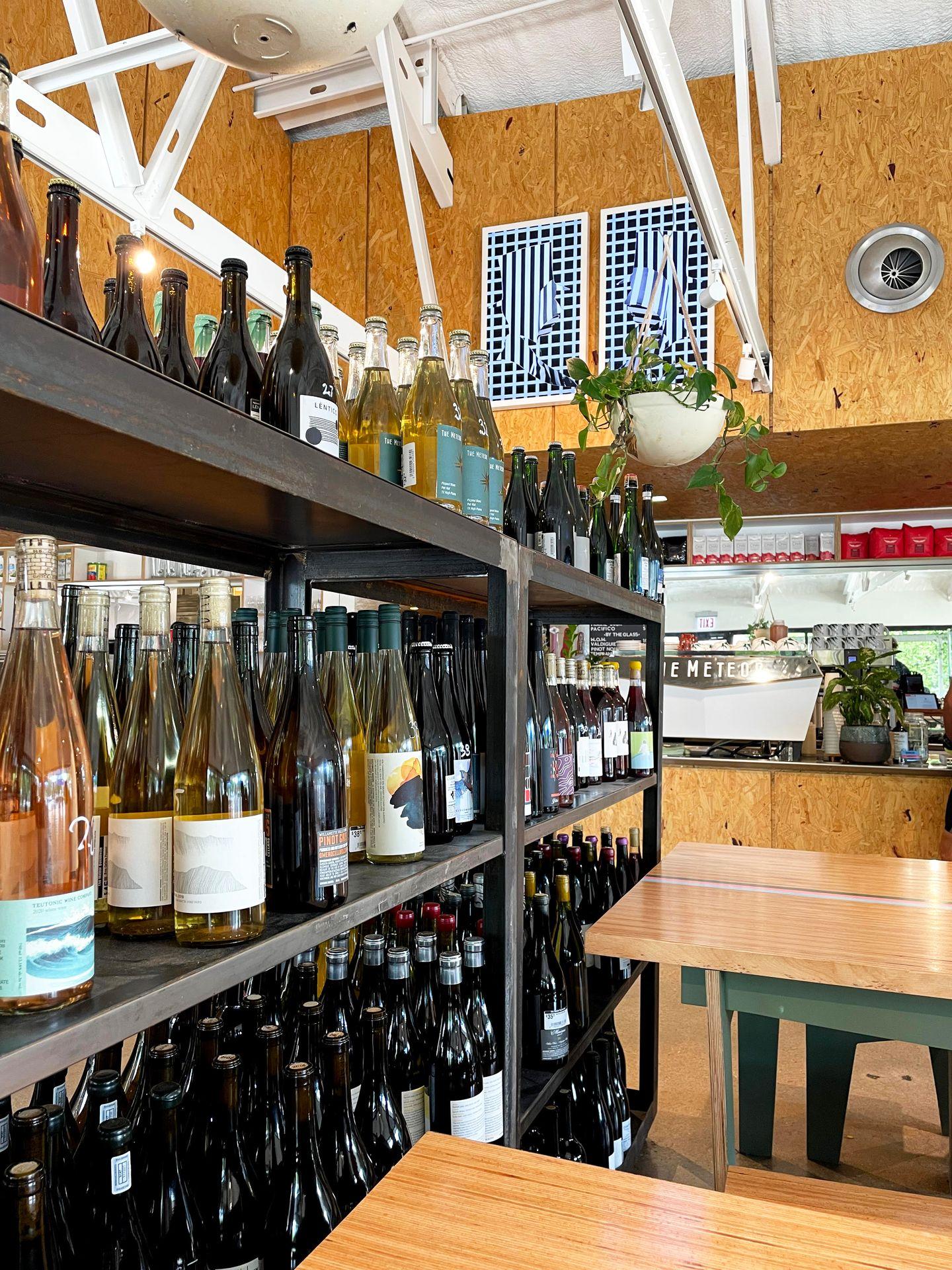 A shelf full of wine bottles inside The Meteor cafe and bar.