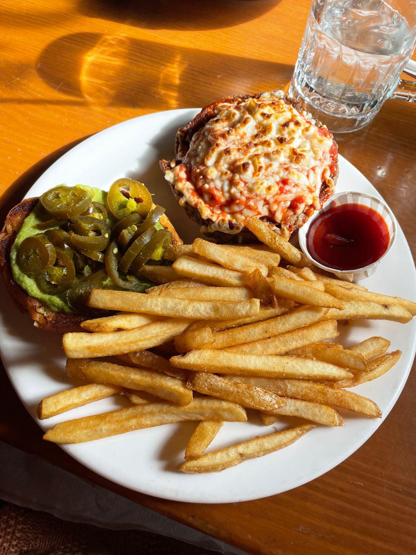 A plate with a burger and fries from Tommy's Neighborhood Pub.