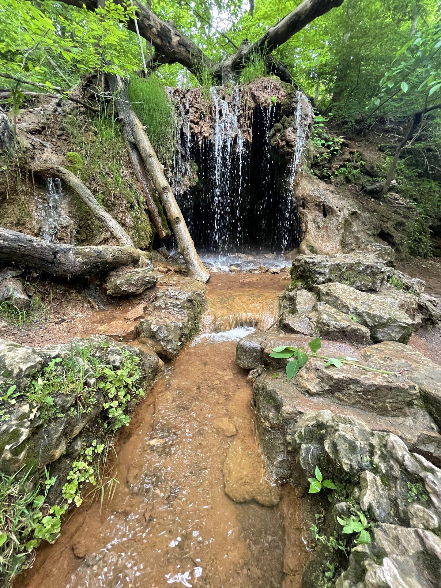A waterfall that cascades over a small cave in Glen Helen Nature Preserve