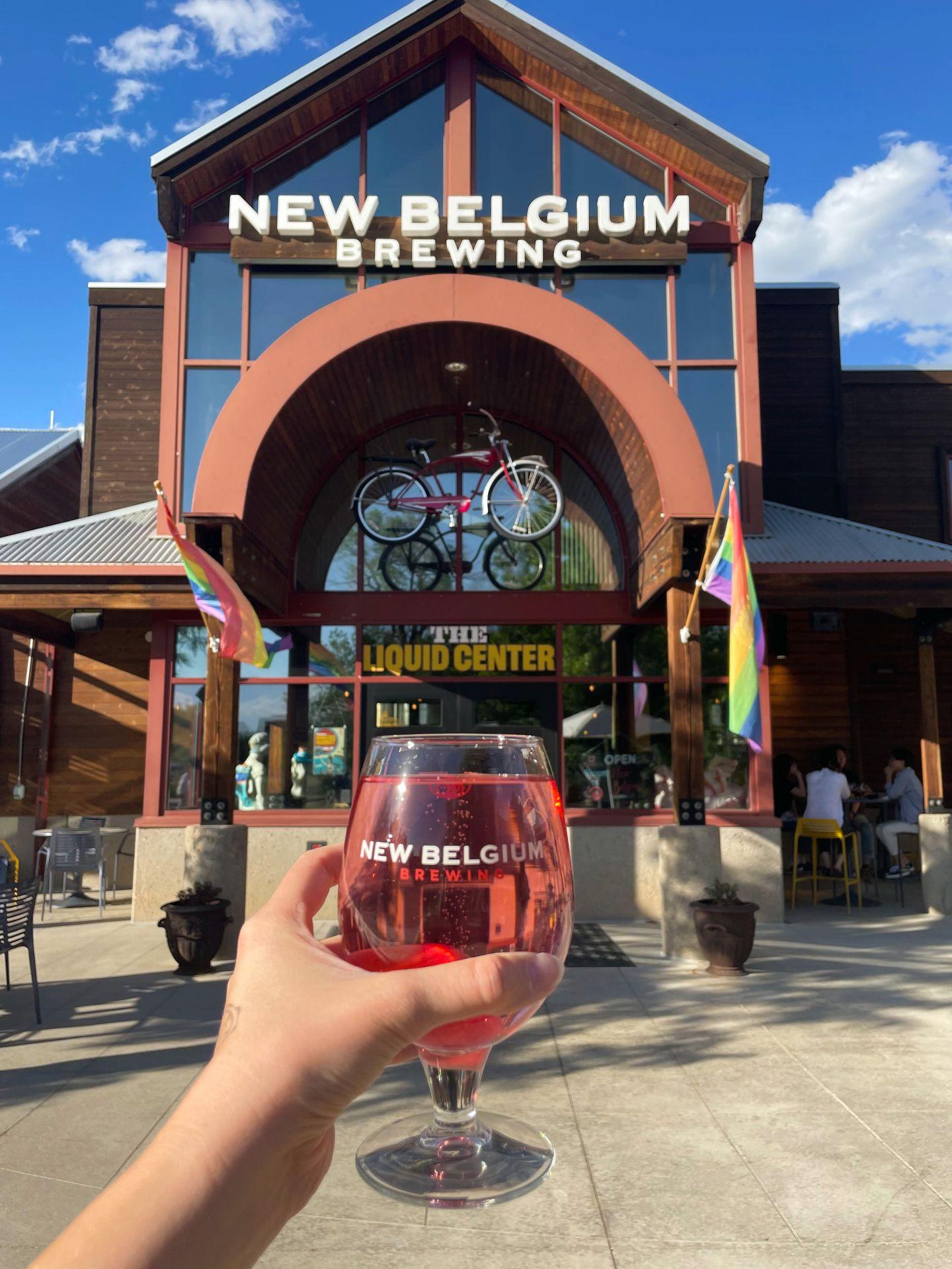 Holding up a red beer in front of the New Belgium Brewing in Fort Collins.