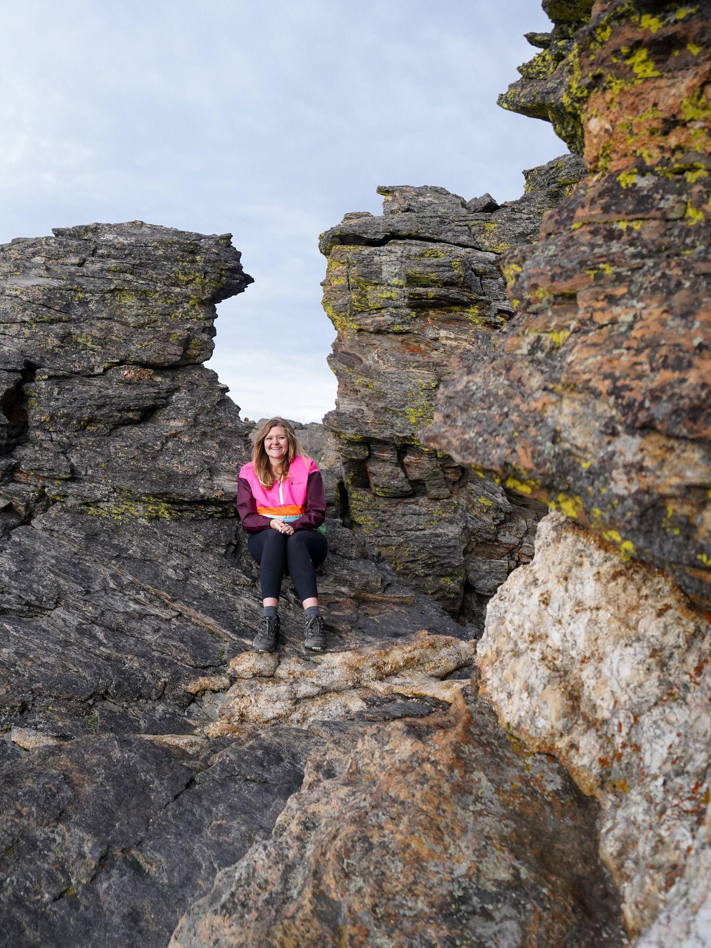 Lydia sitting on interesting rock formations along on Tundra Communities Trail.