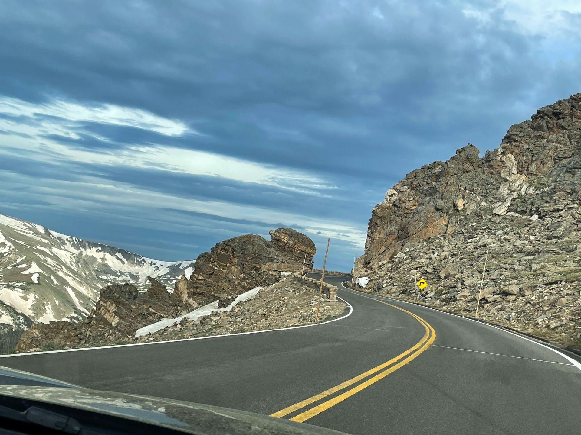 A windy road leading through some giant, rock formations along Trail Ridge Road in Rocky Mountain National Park.