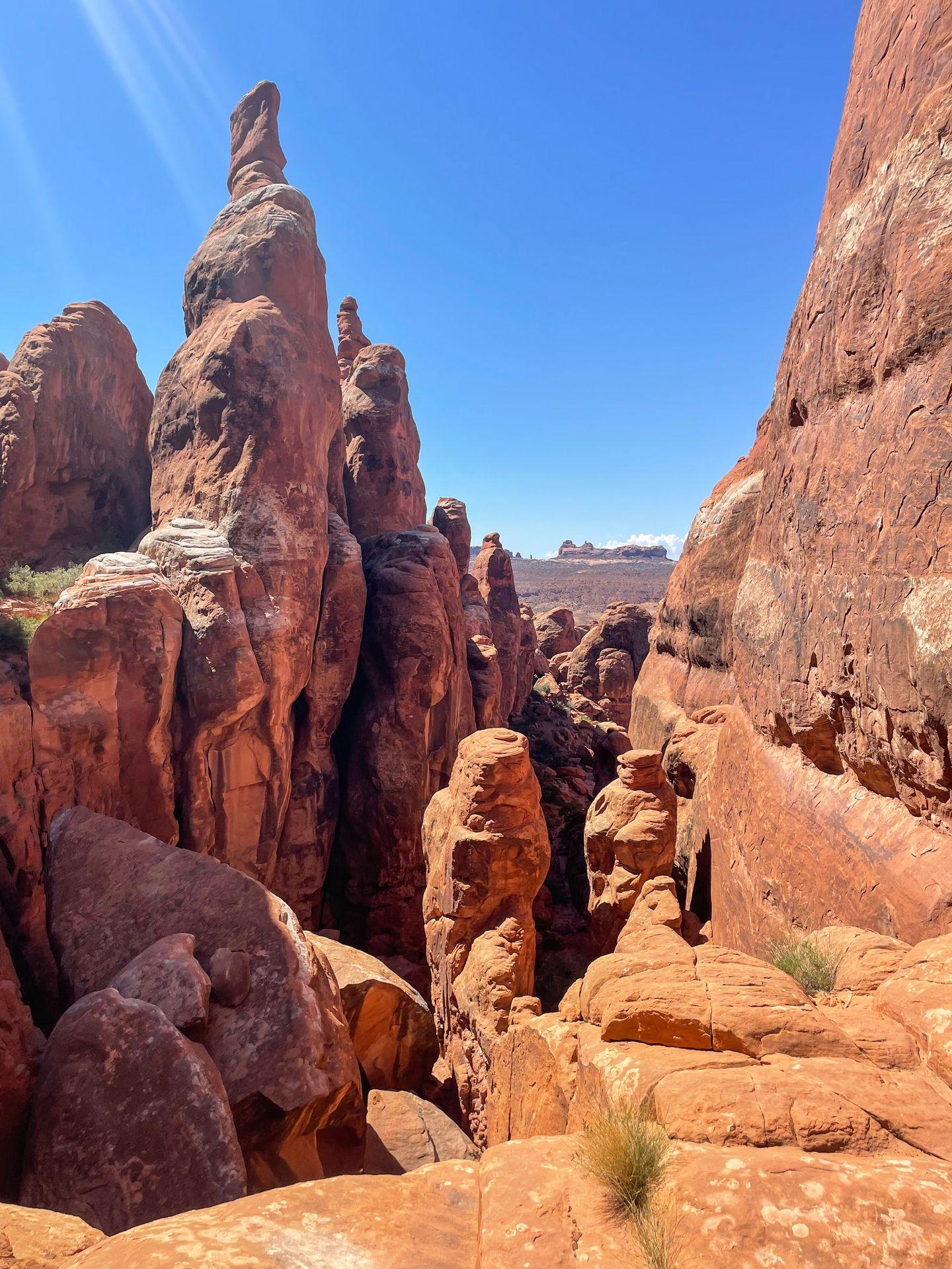 Towering orange rock formations inside the Fiery Furnace in Arches National Park.