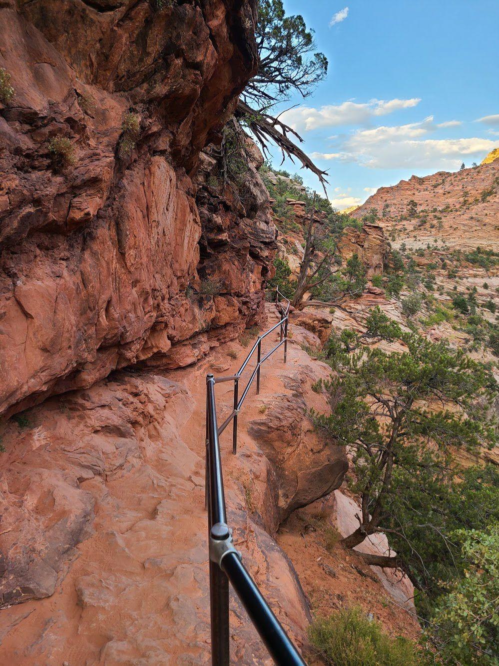 A narrow ledge with a railing on the Canyon Overlook Trail in Zion National Park.
