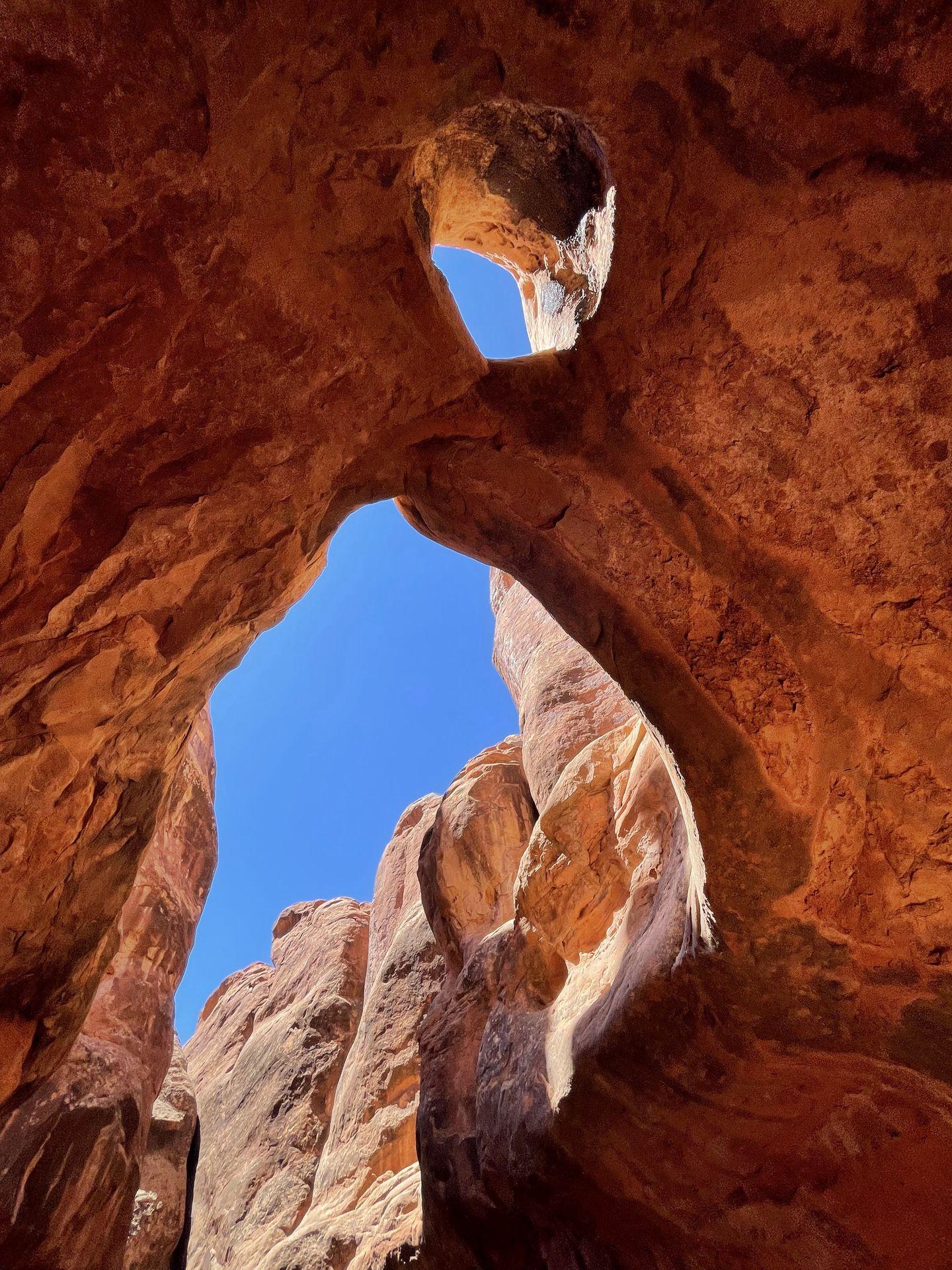 Looking up at a window inside of a cave on the Fiery Furnace trail