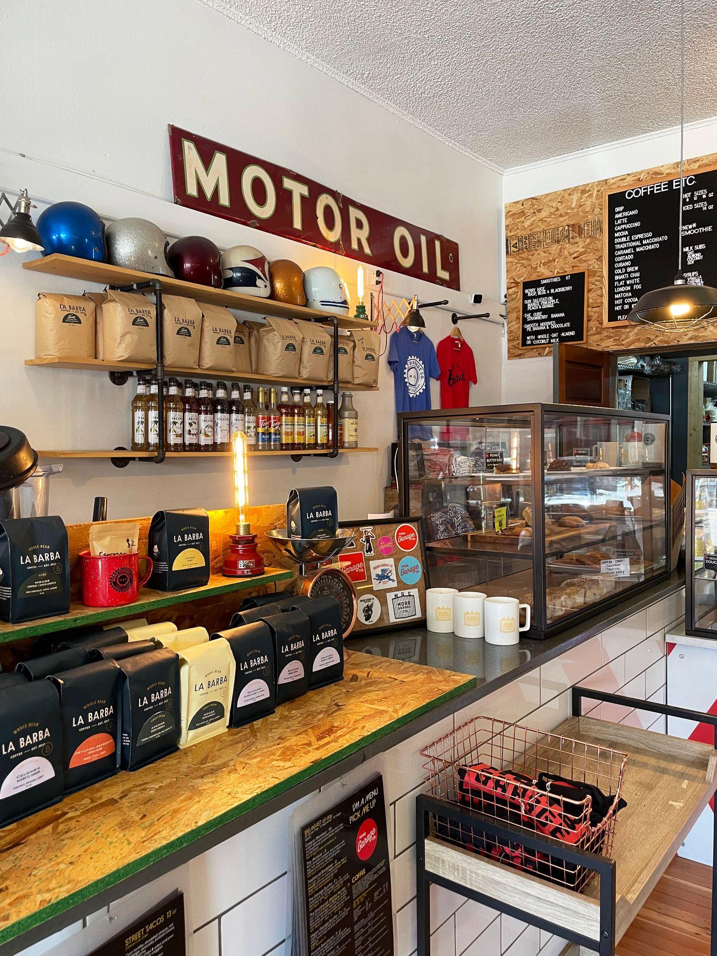 The interior of Moab Garage Co. There are bags of coffee beans on the counter and a sign that reads "motor oil" behind the counter.