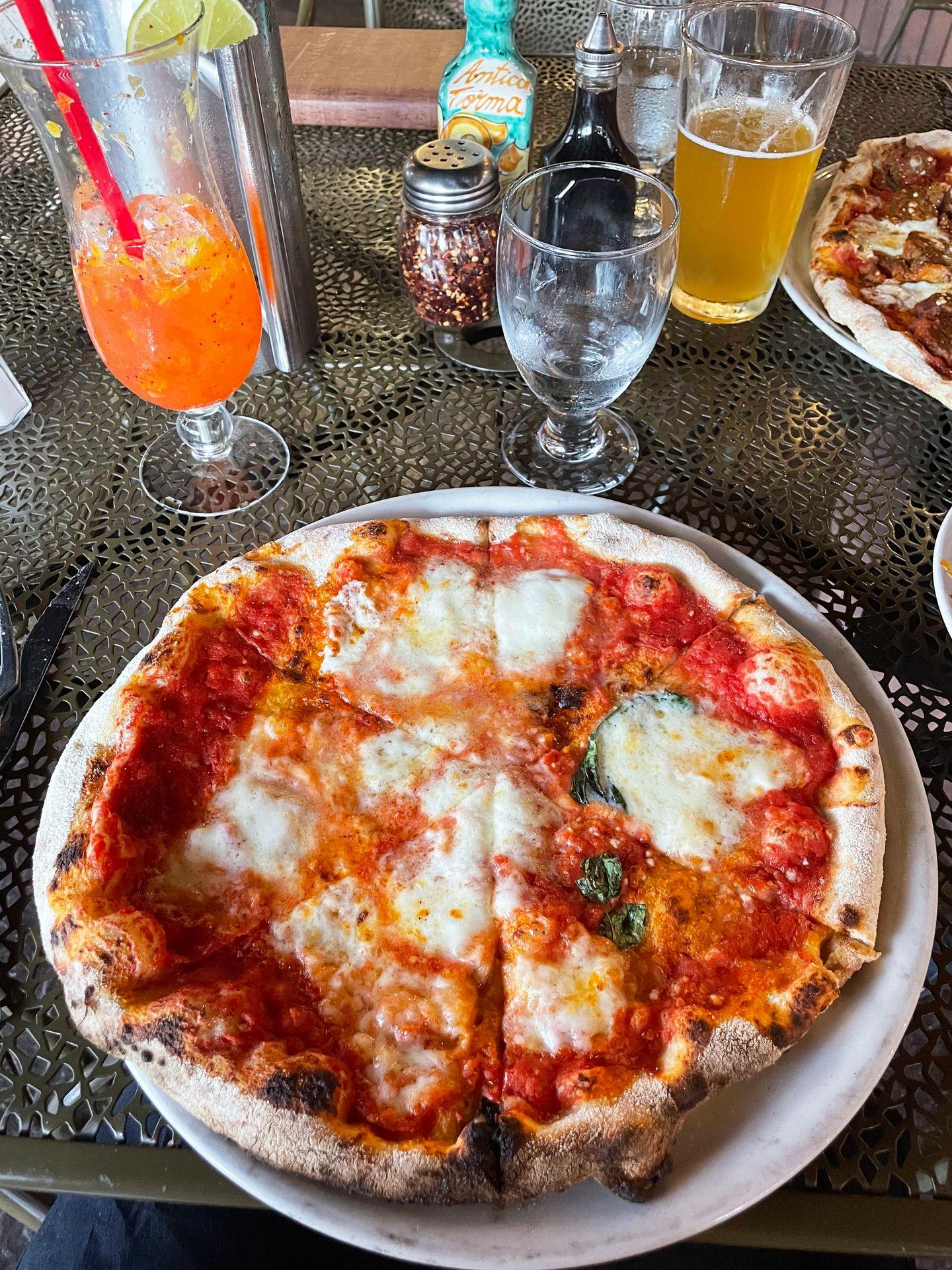 A pizza with tomato sauce and mozzarella cheese from Antica Forma.