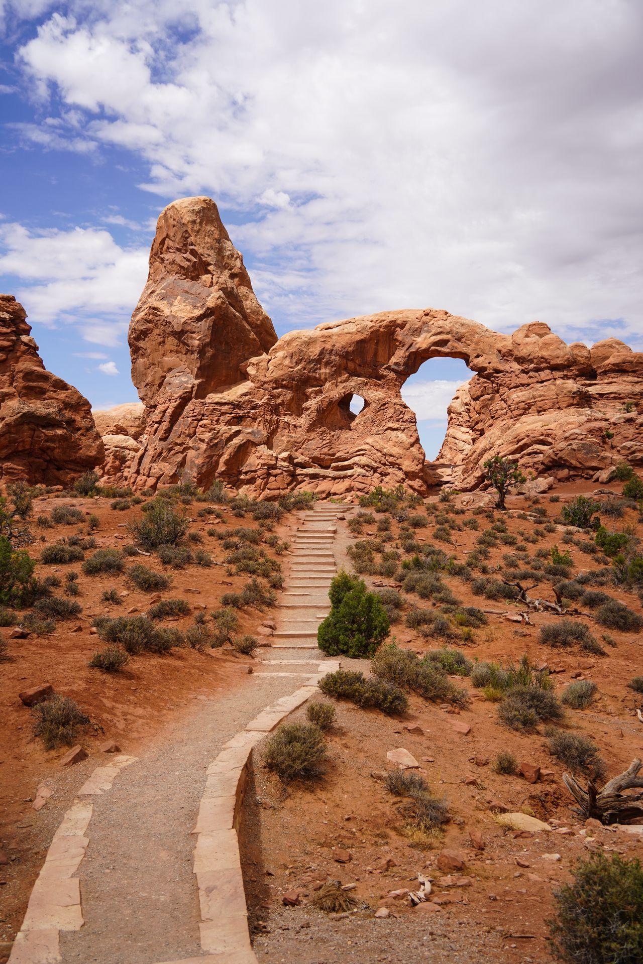 A trail and steps leading up to the turret arch
