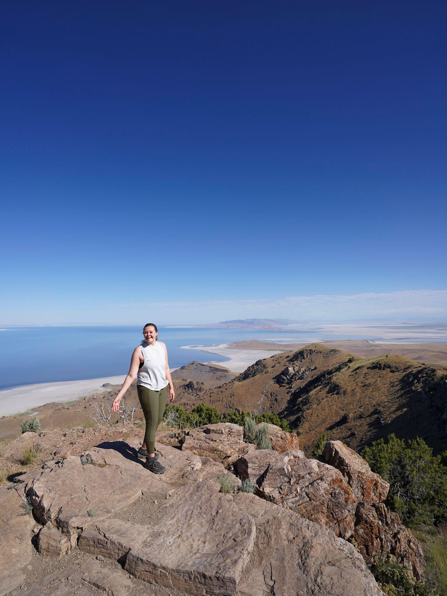 Lydia standing on top of Frary Peak with a view of the Great Salt Lake in the distance.