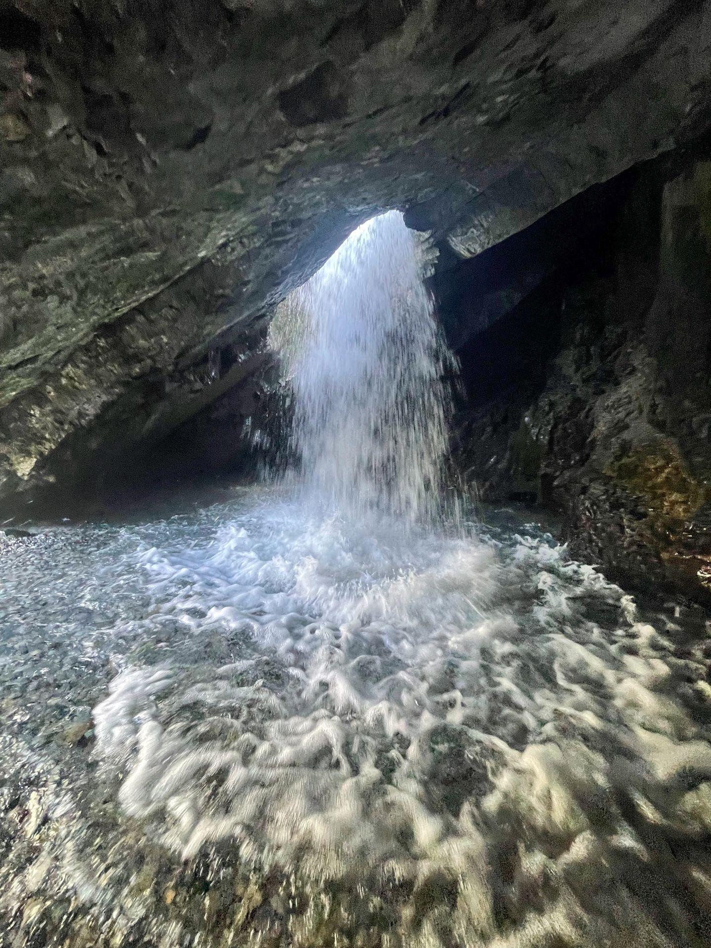 A heavy stream of water flowing through the hole, seen from below.