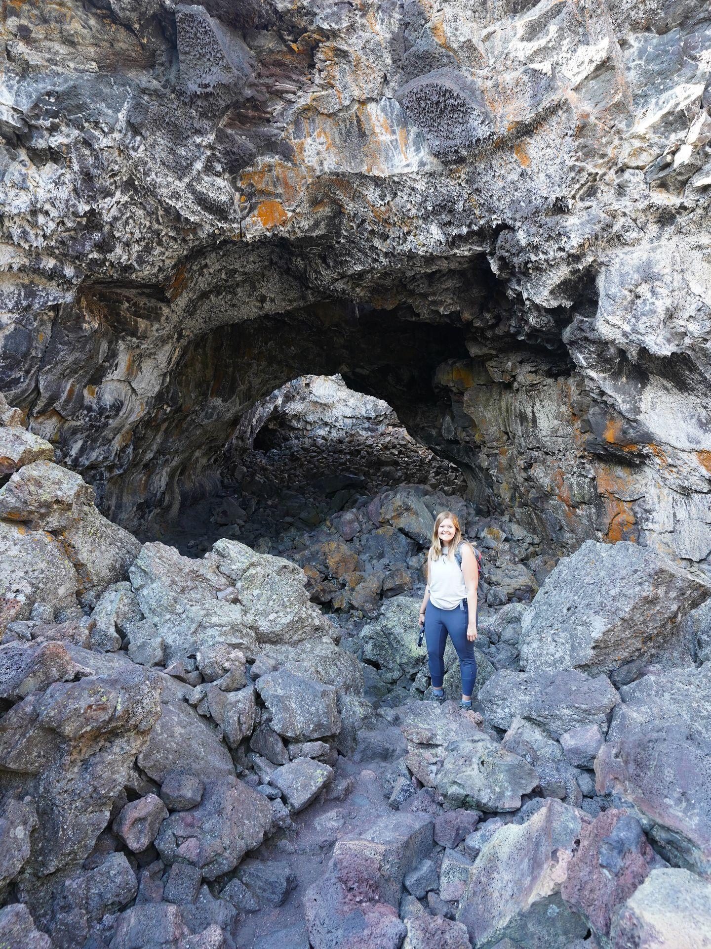 Lydia inside a large cave at Craters of the Moon.