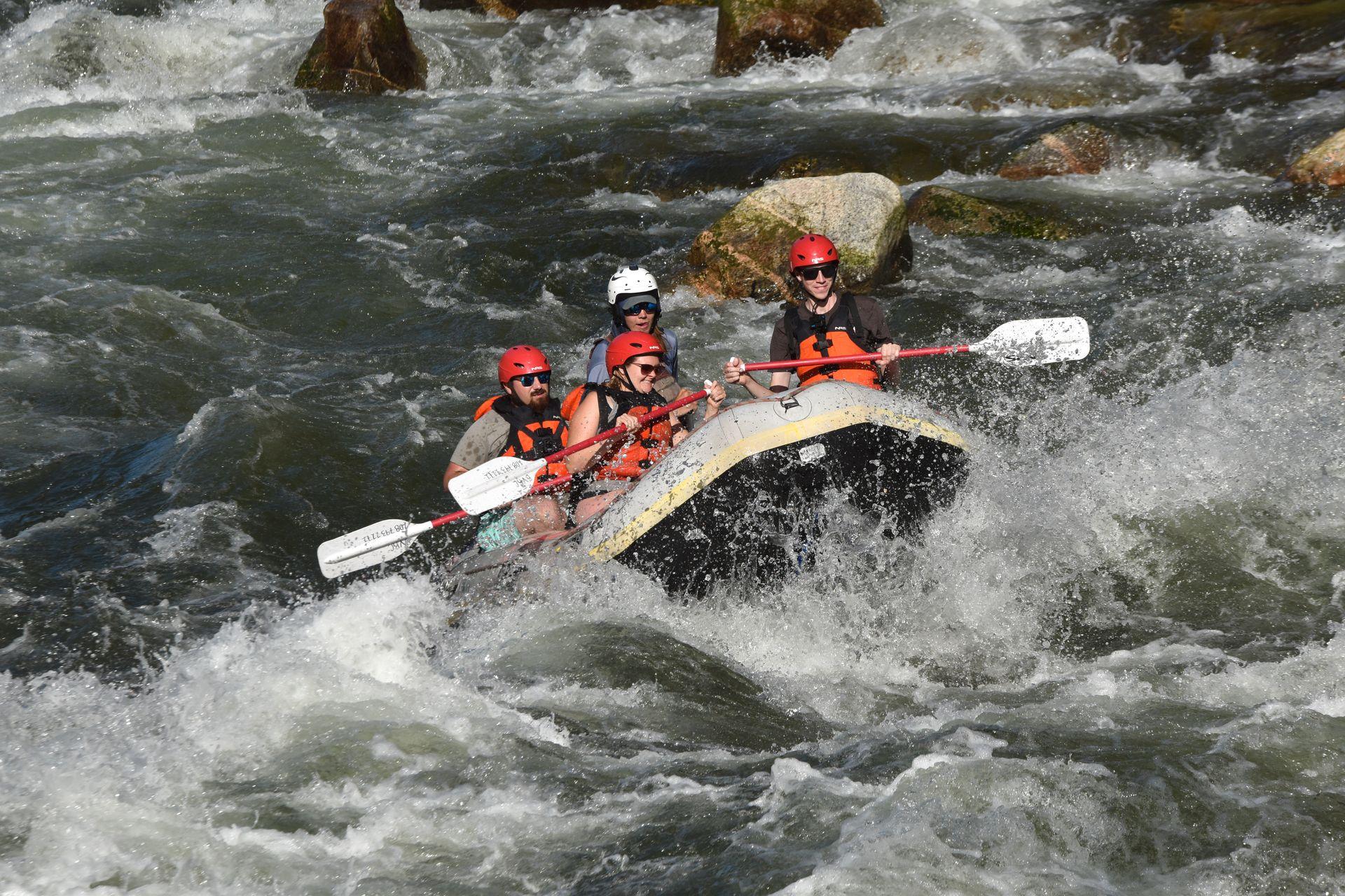 Lydia and others going over a rapid while white water rafting on the Payette River.