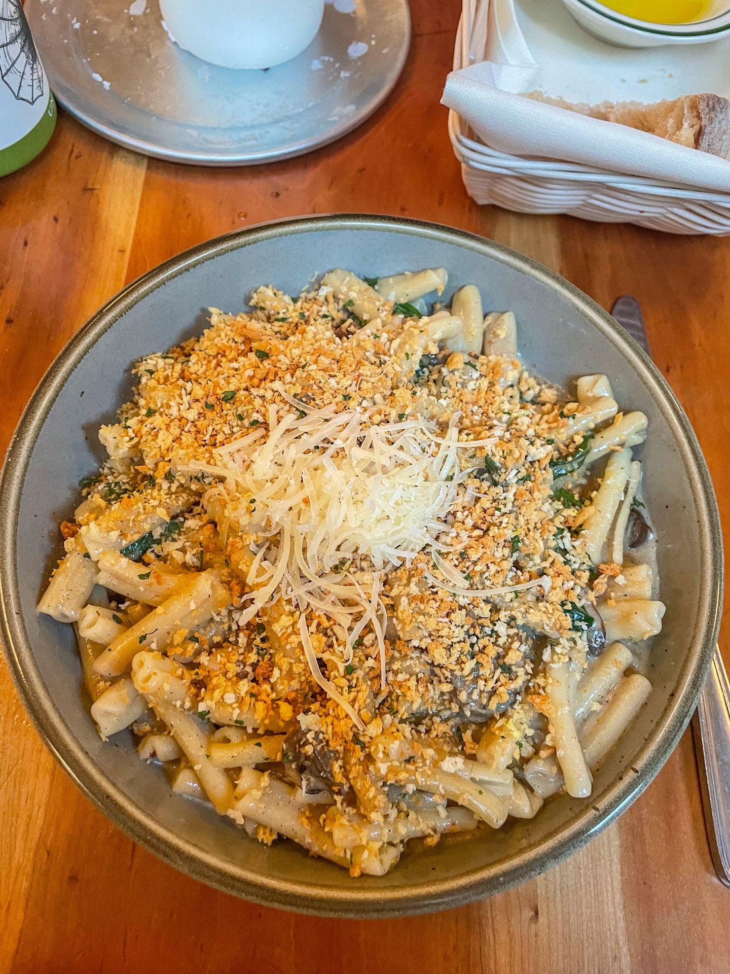 A plate of truffle pasta topped with cheese from Moosewood.