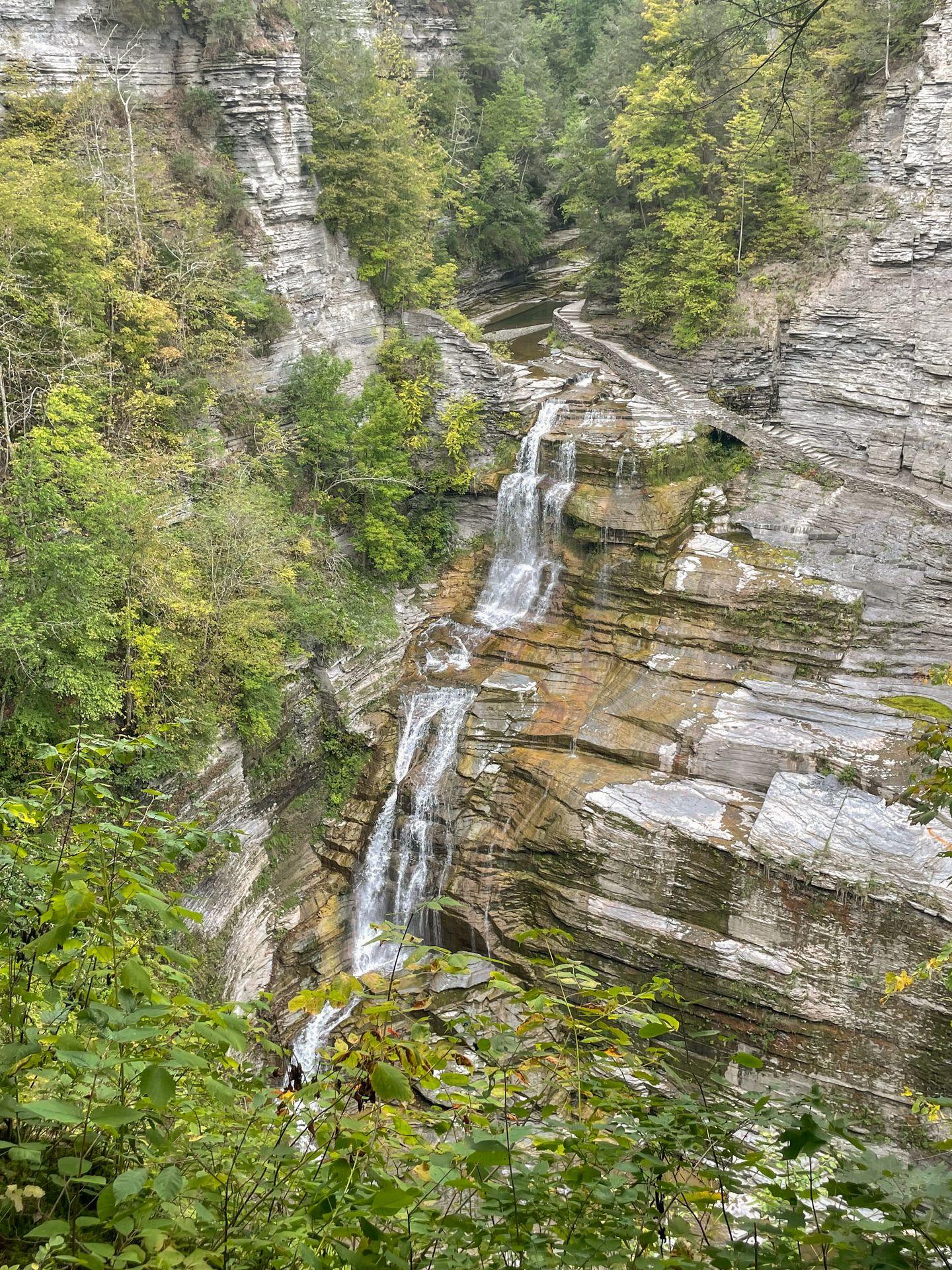 A narrow waterfall falling down a tall gorge at Robert H. Treman State Park.