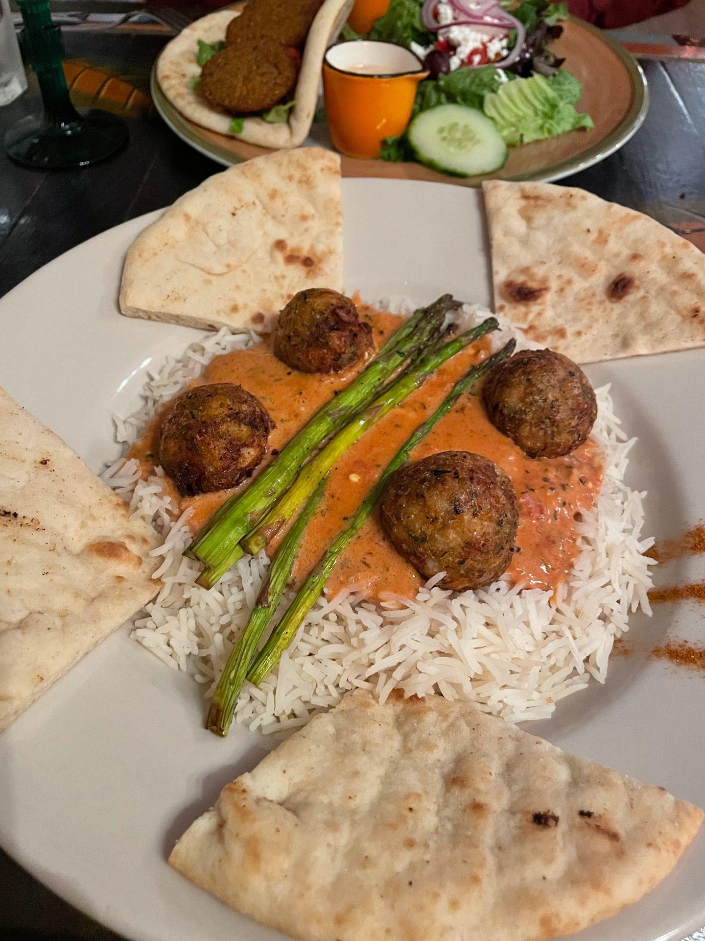 A plate of rice, pita bread, falafel and a red sauce from Gypsy Cafe.