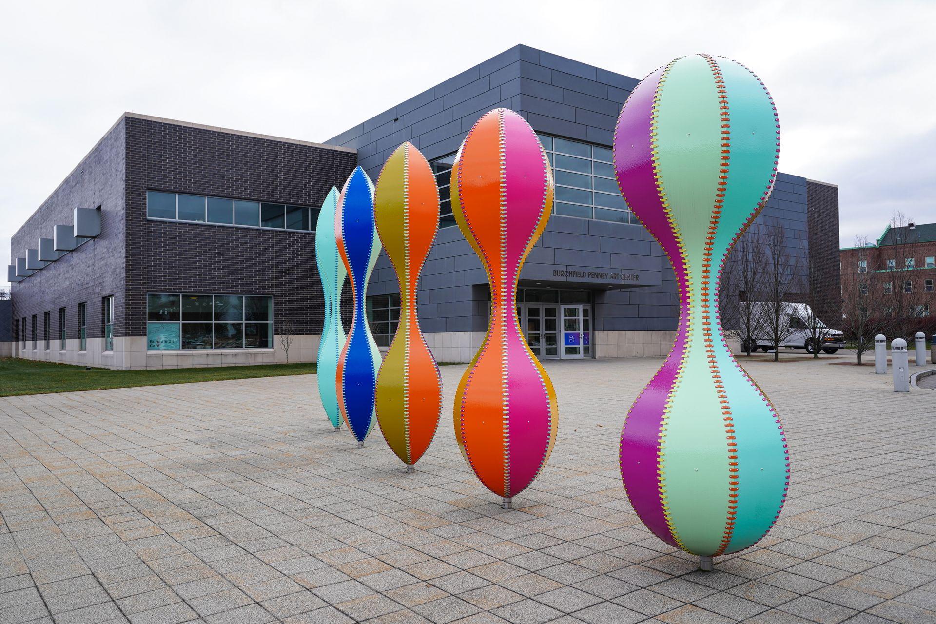 Five colorful and round sculptures outside of the Burchfield Penney Art Center in Buffalo.