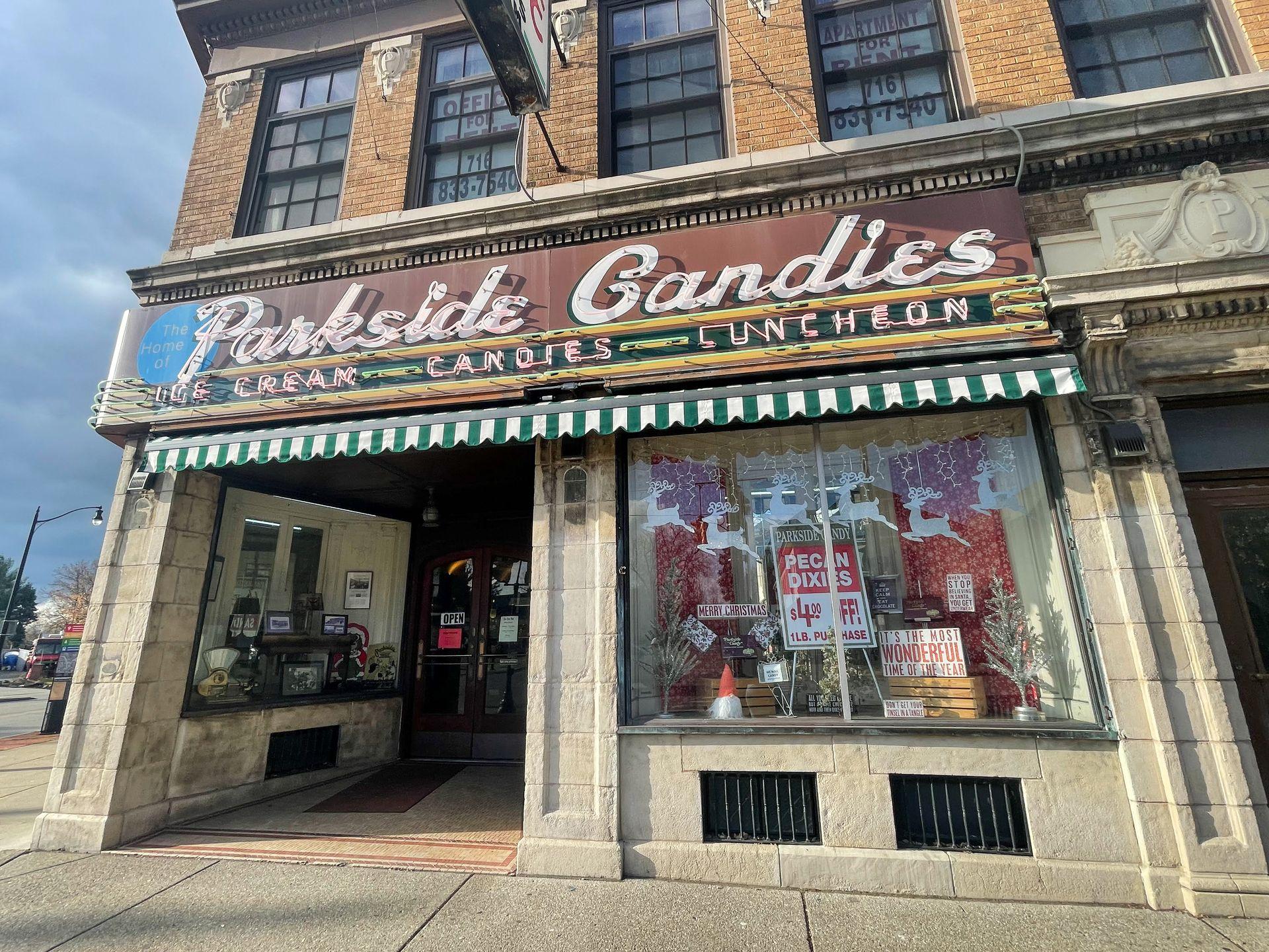 The exterior of a vintage building that reads 'Parkside Candies: Ice Cream, Candies, Luncheon'