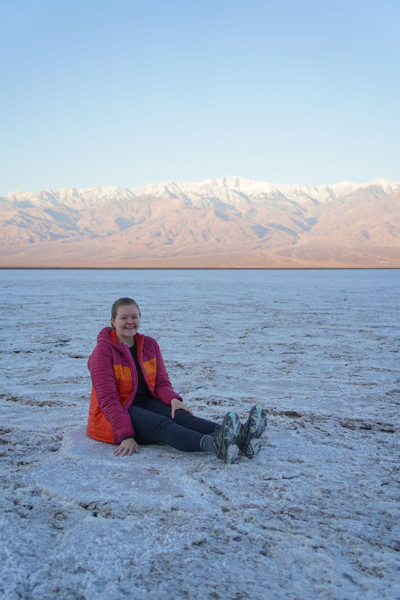 Lydia sitting on the salt flats in Badwater Basin in Death Valley.