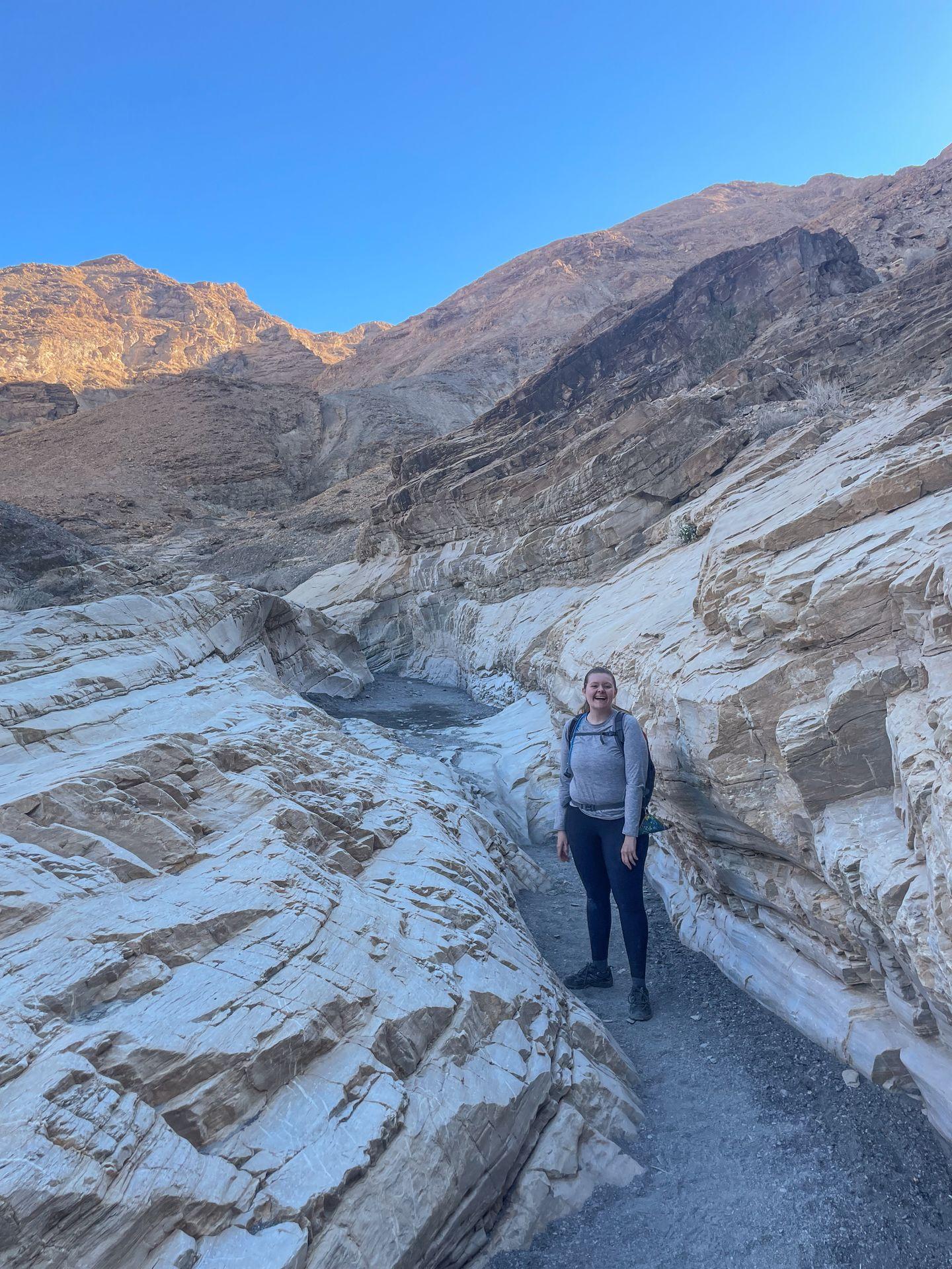 Lydia standing between canyon walls on the Mosaic Canyon trail.