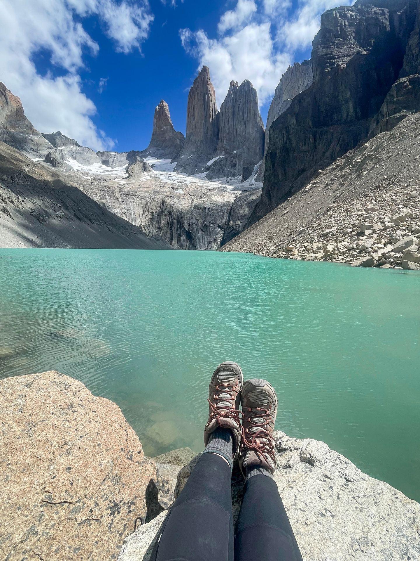 A view of Lydia wearing Merrell hiking boots with Mirador Las Torres in the background.