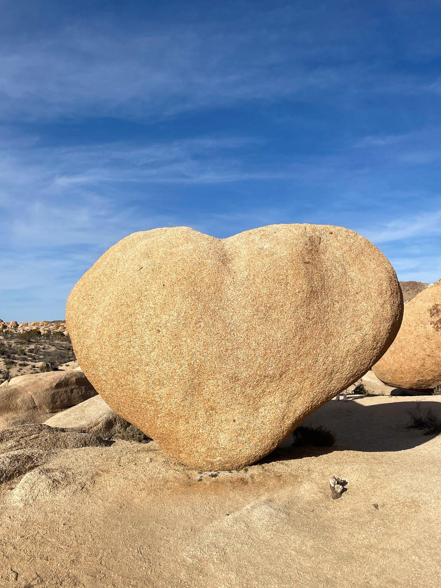 A tall boulder that seems to resemble a heart shape.