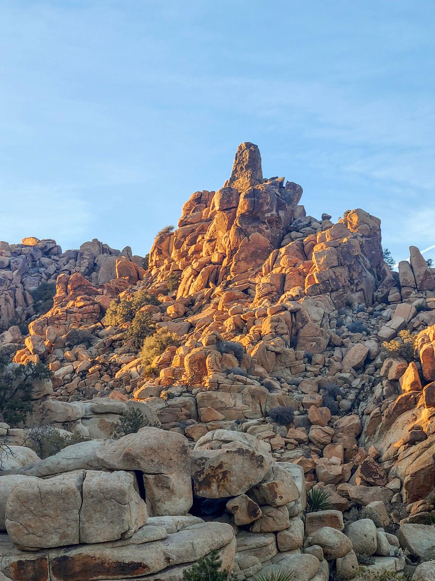 A pile of interesting rocks glowing orange at golden hour on the Hidden Valley Trail.