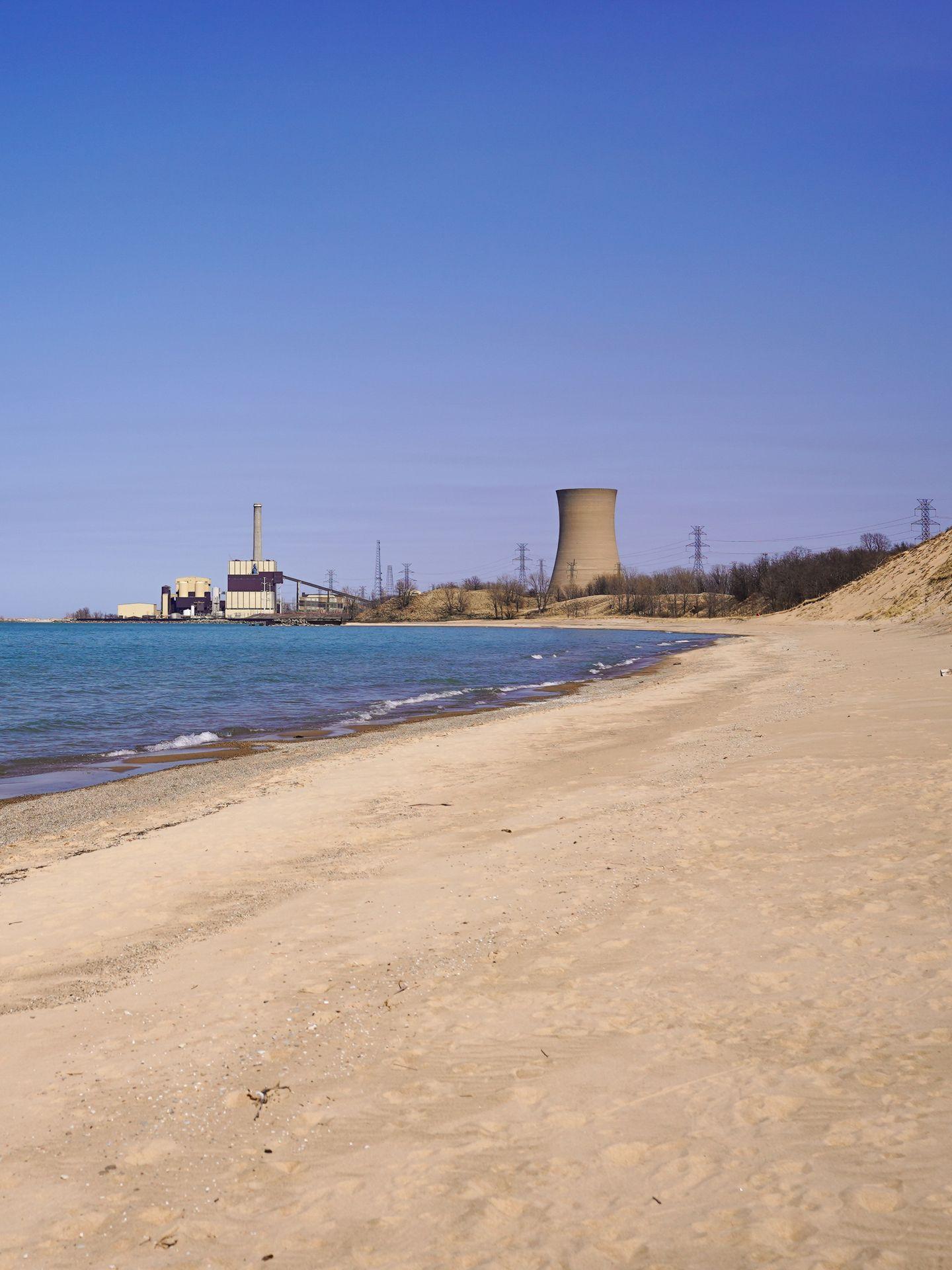 A beach with a view of a former factory.