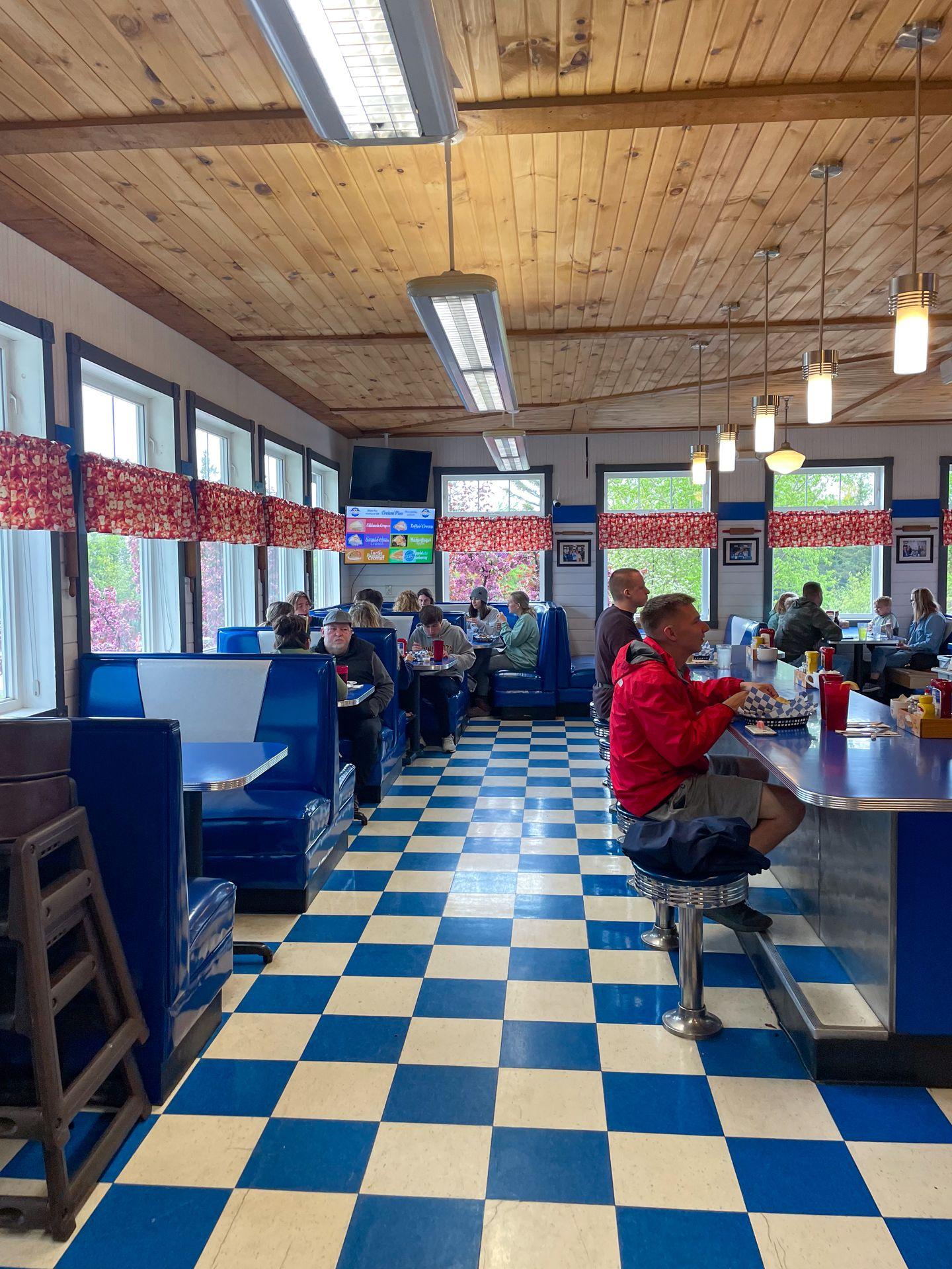 The interior of Betty's Pies, which features a blue and white checkerboard floor and blue booths.