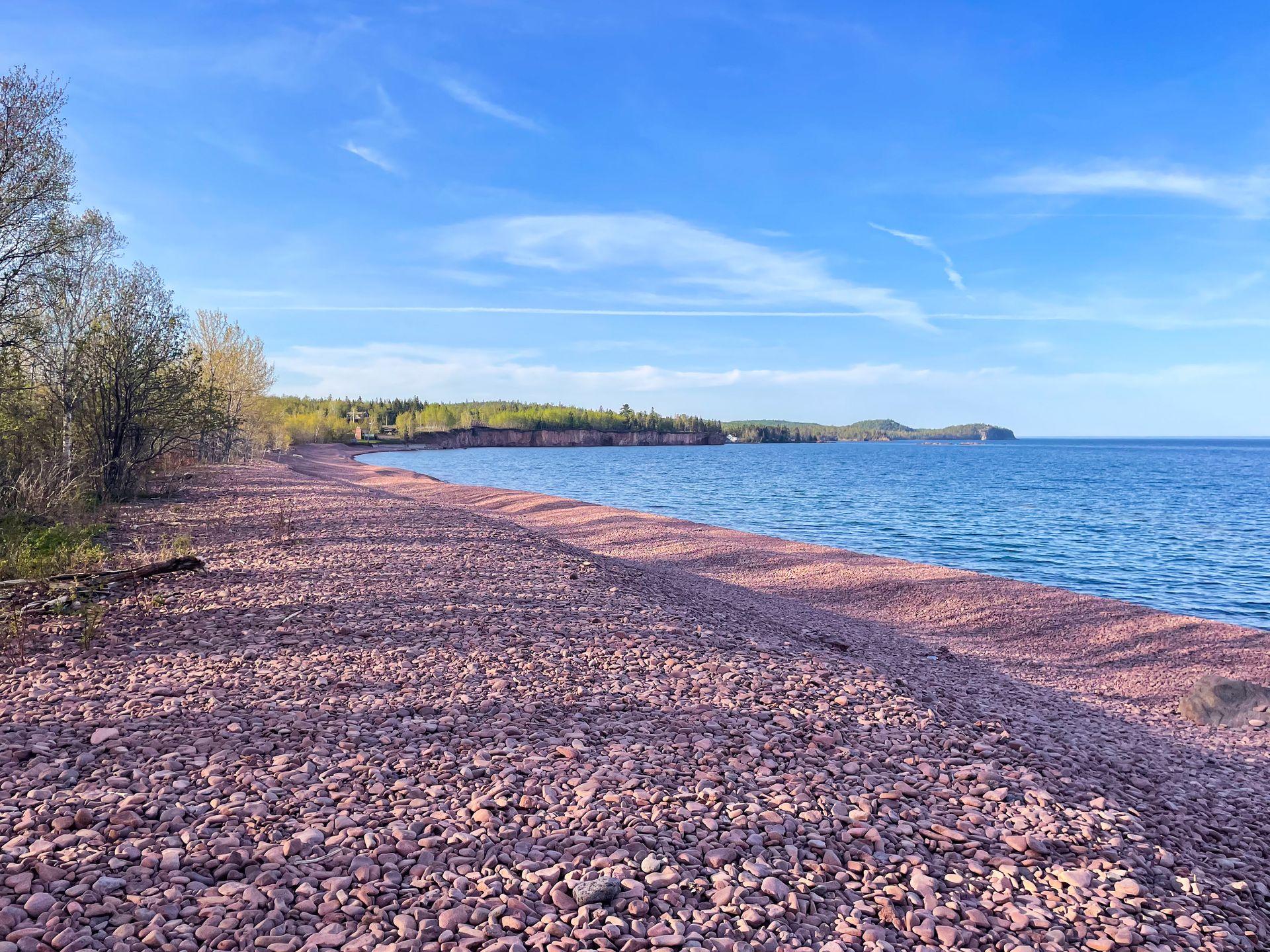 A rocky beach made up entirely of pinkish rocks.