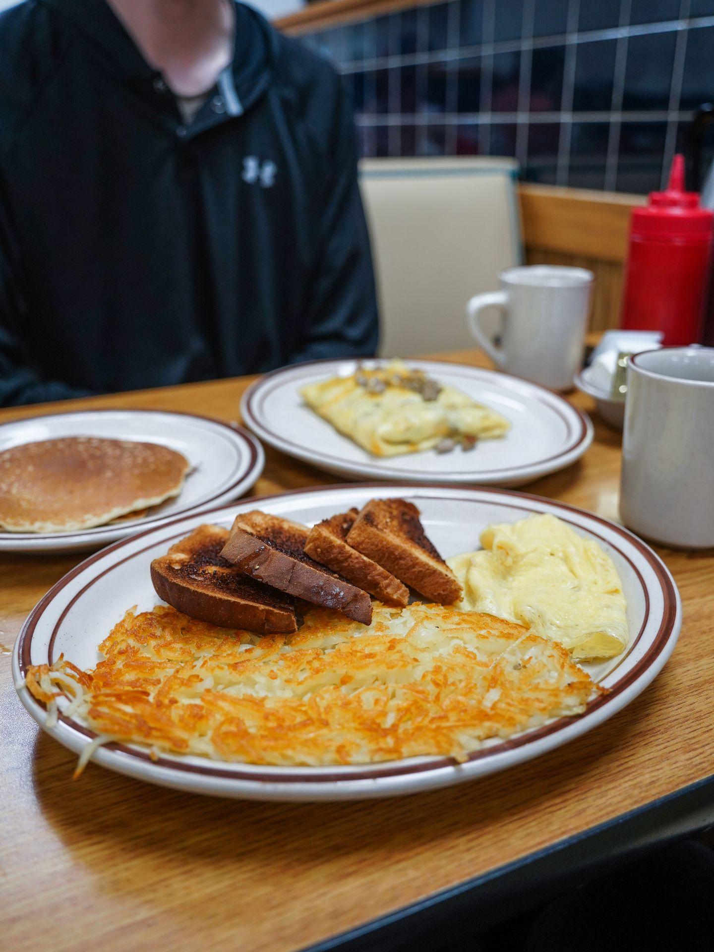 A plate of hashbrowns, toast and eggs at Brigitte's Cafe