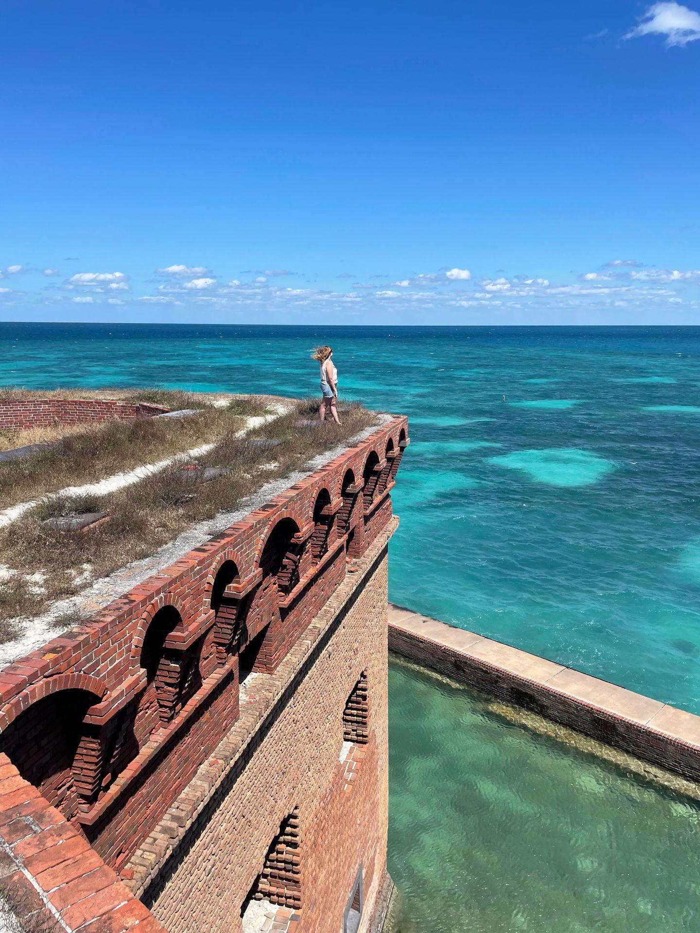 Lydia standing on the corner of a fort at Dry Tortugas National Park.