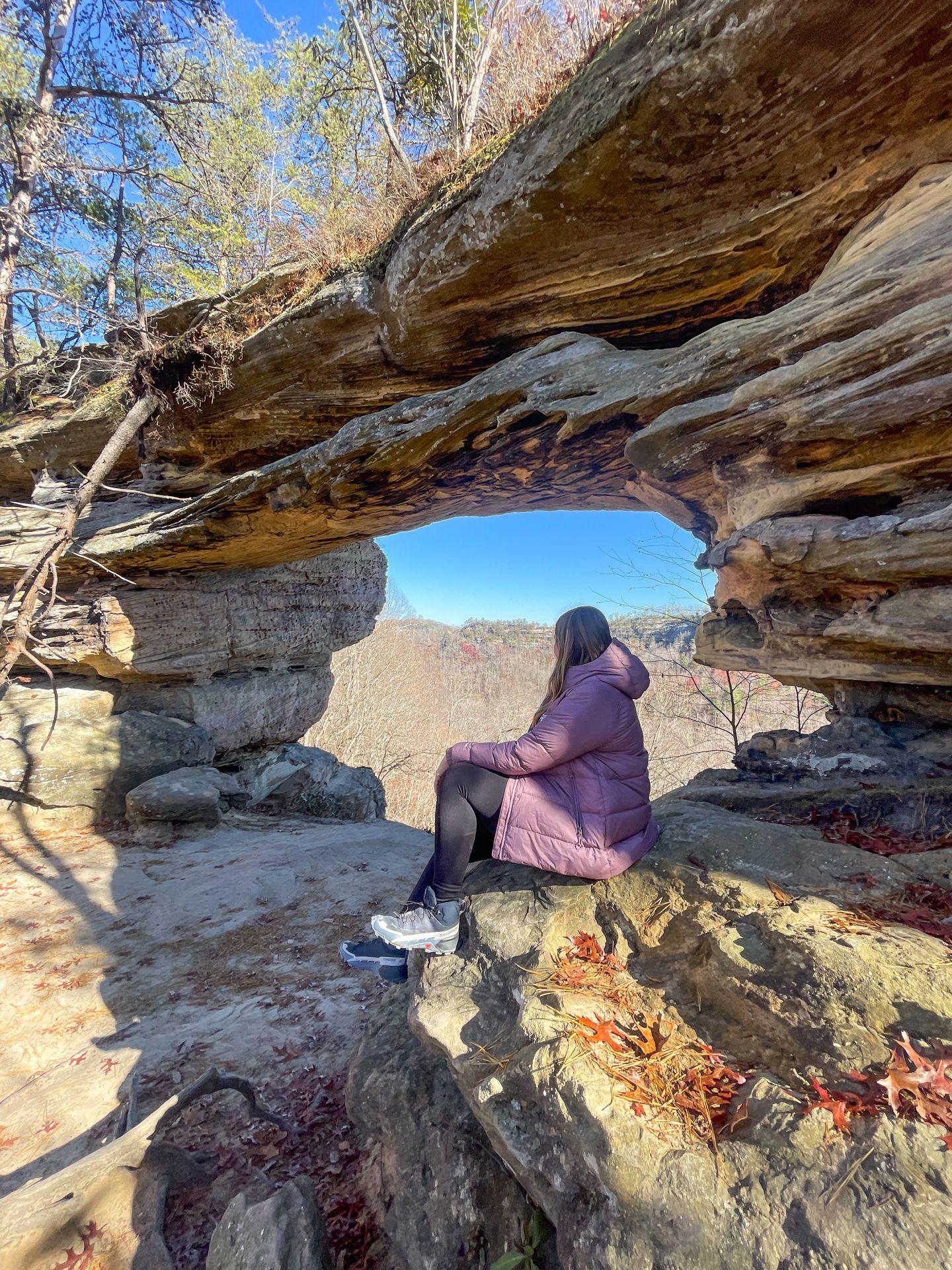 Lydia sitting in front of Double Arch at Red River Gorge
