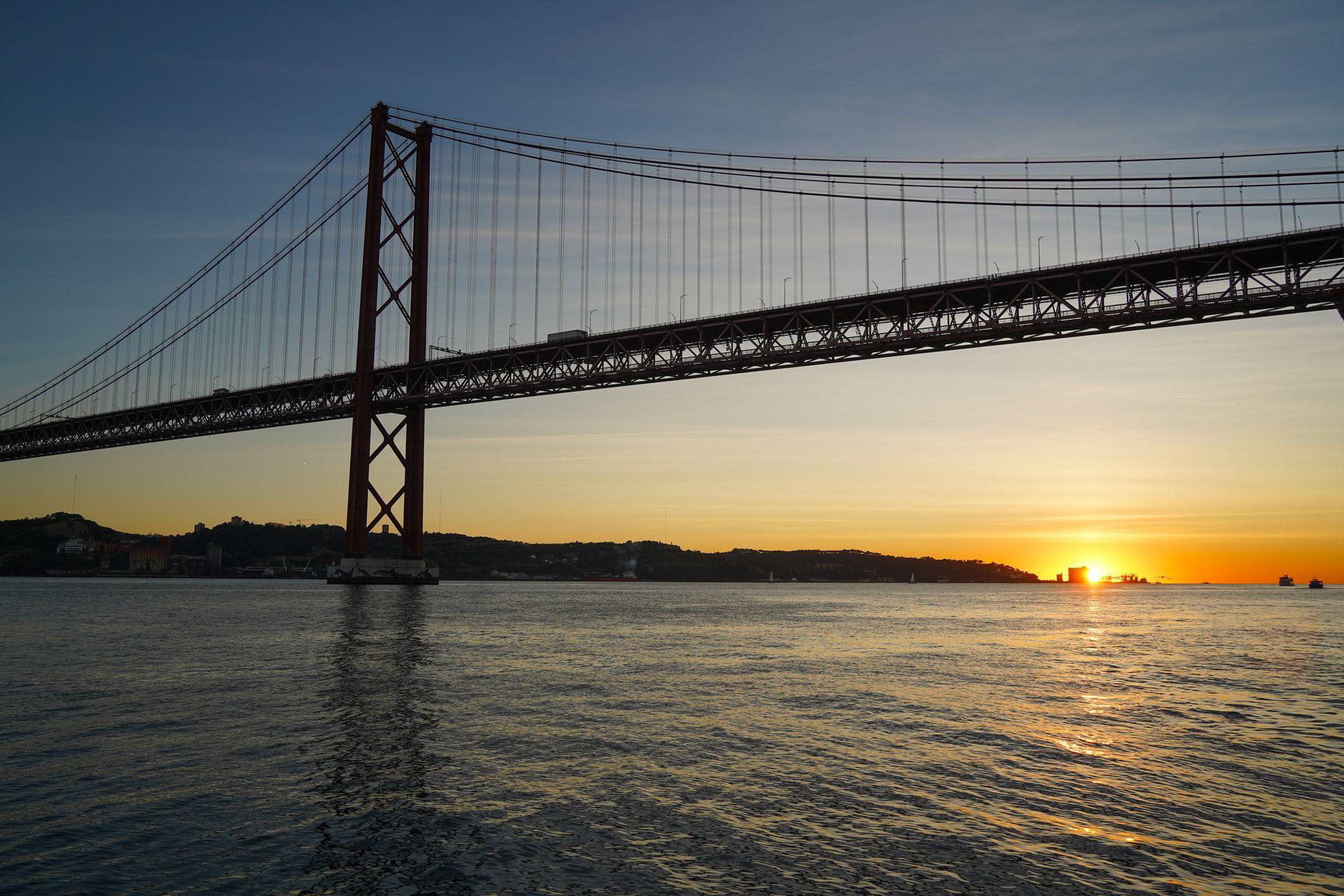 Looking at the Ponte 25 de Abril Bridge during sunset.