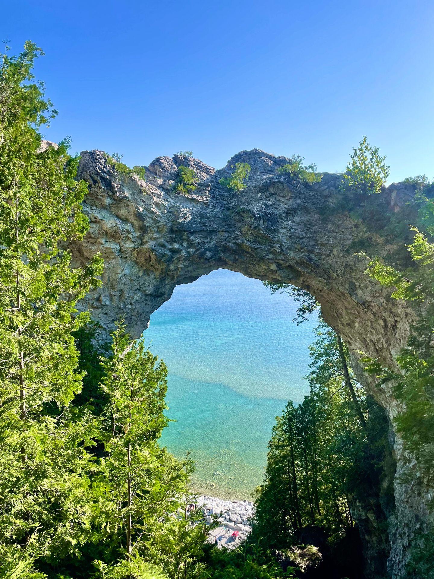 Looking directly at Arch Rock with the aqua-blue color of Lake Huron seen through the arch.
