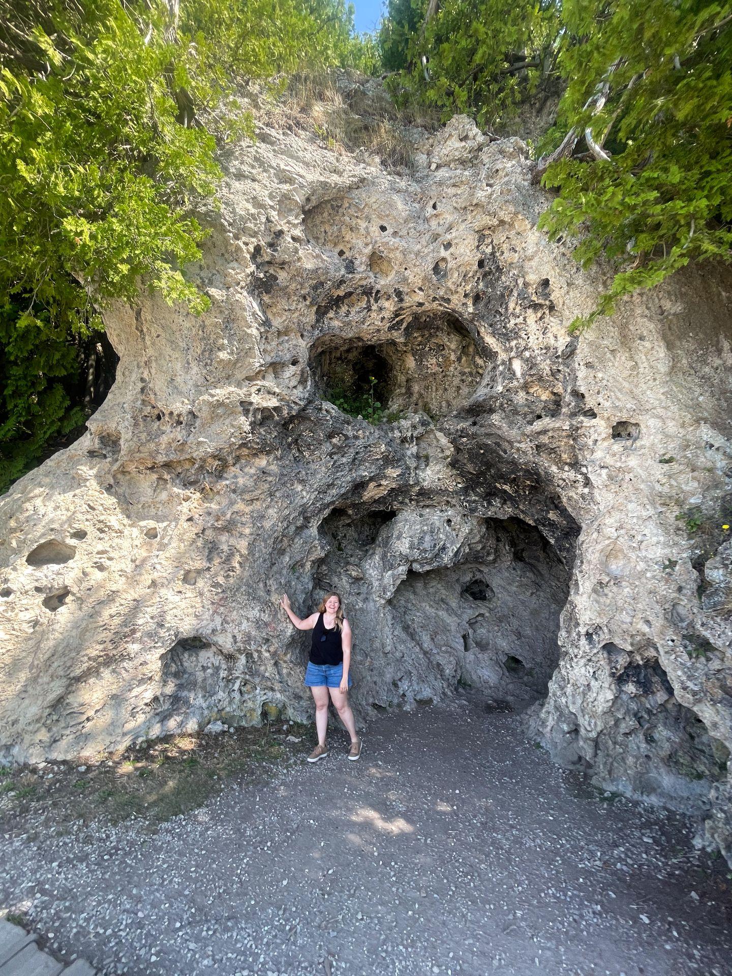 Lydia standing in front of a limestone rock formation.