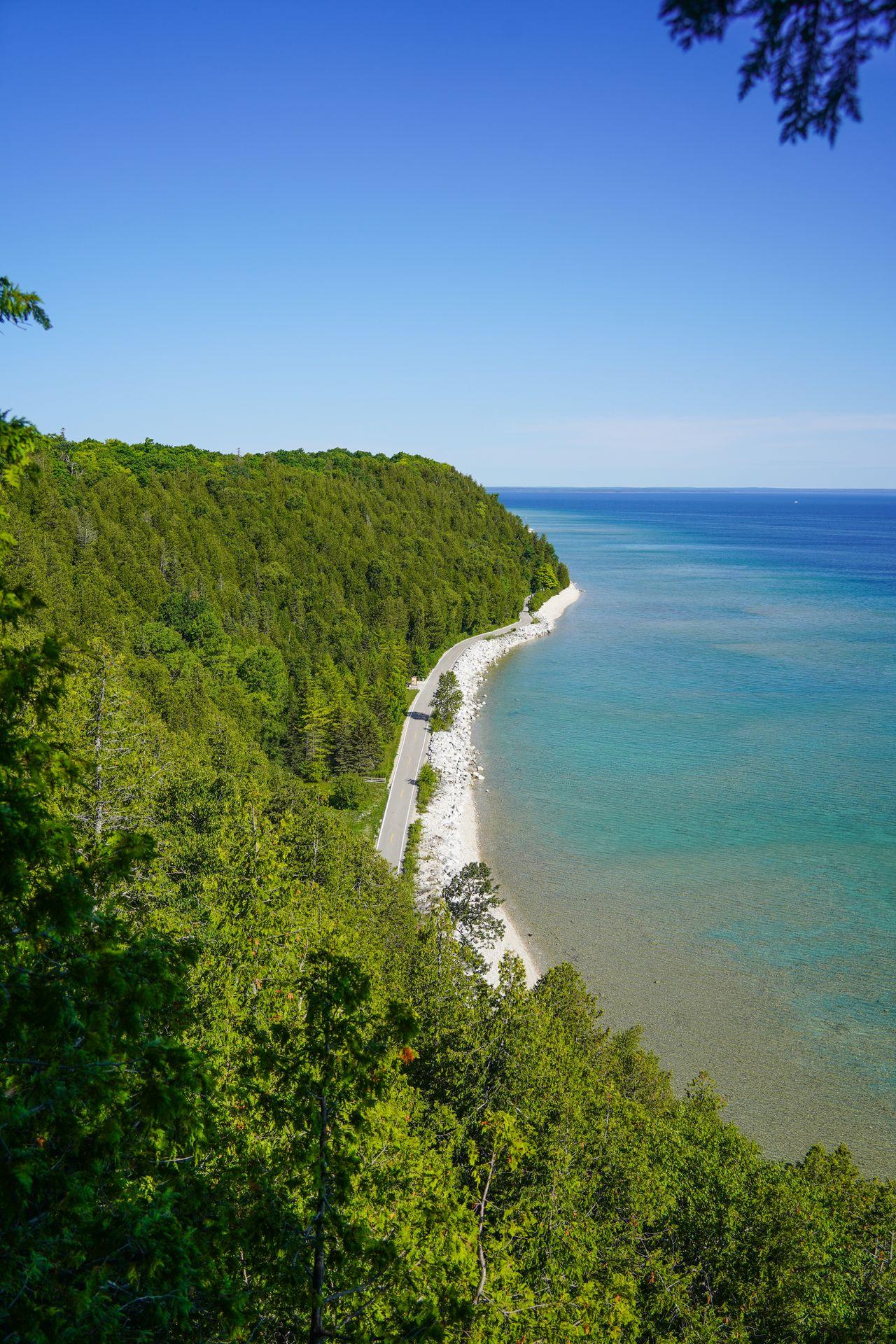 Looking at the shoreline of the island and the loop road from the Tranquil Bluff Trail on Mackinac Island.