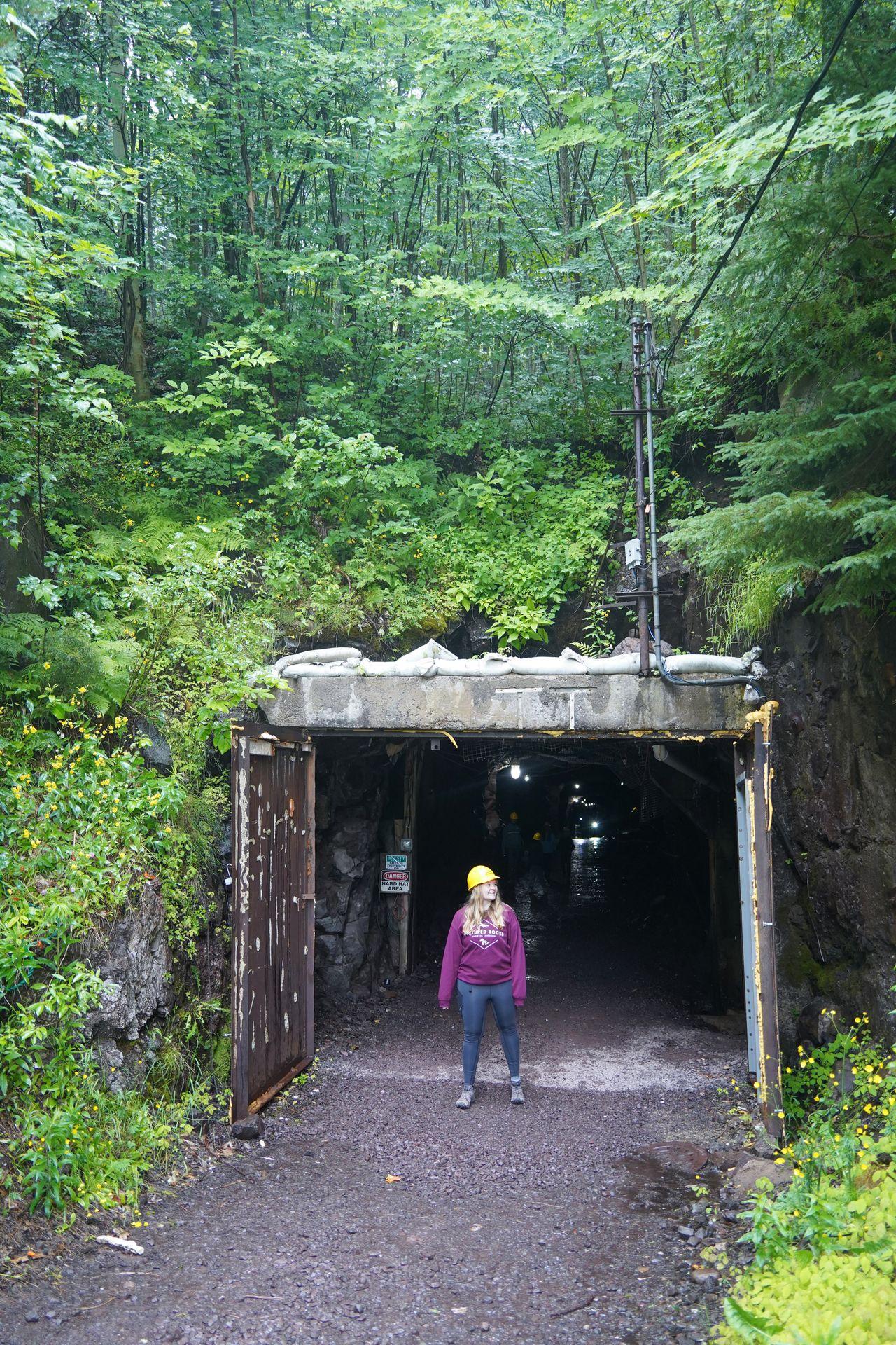 Lydia standing in front of the entrance to Quincy Mine