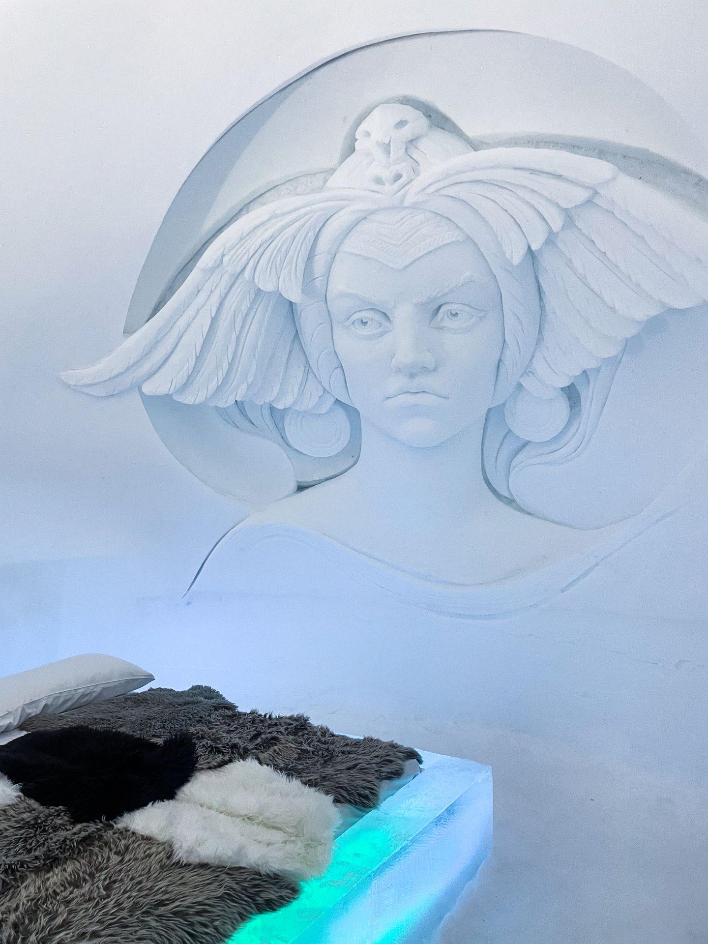 An ice bed with the face of a woman carved on the wall