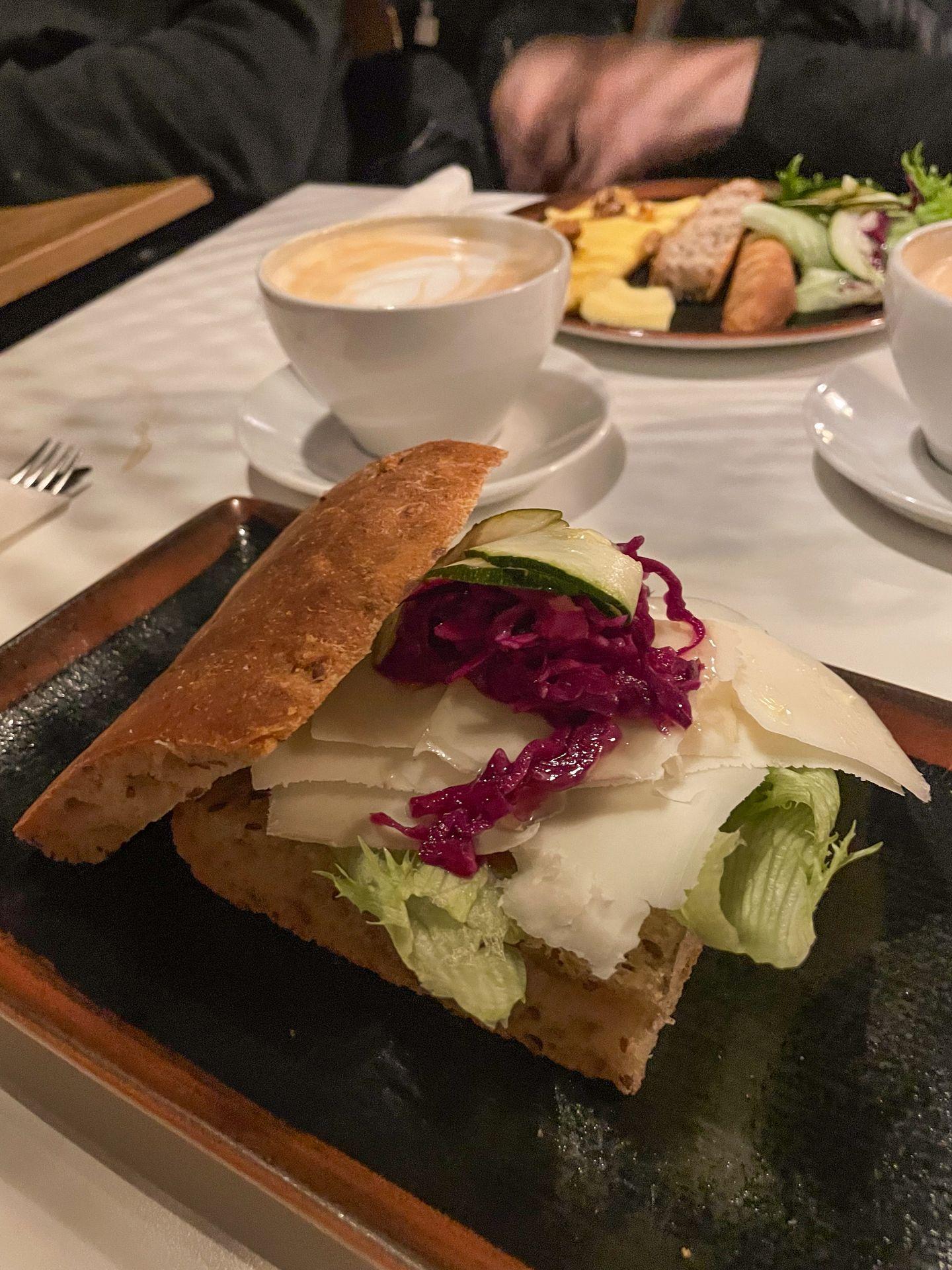 A sandwich with cheese, lettuce and other items from Risø mat og kaffebar