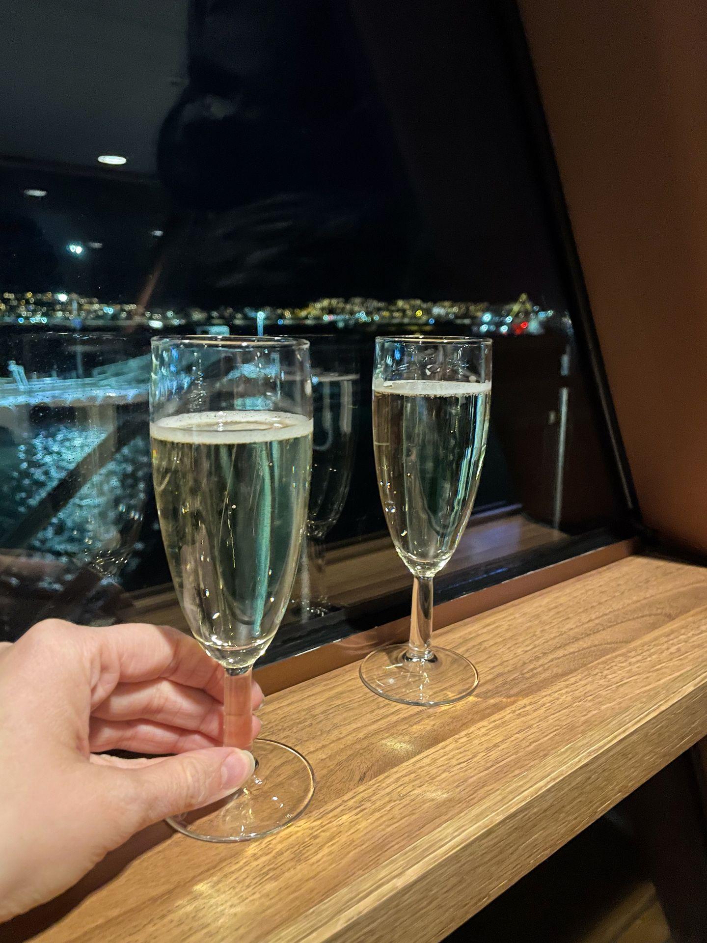 Two glasses of bubbly wine wine at the window of the Northern Lights cruise