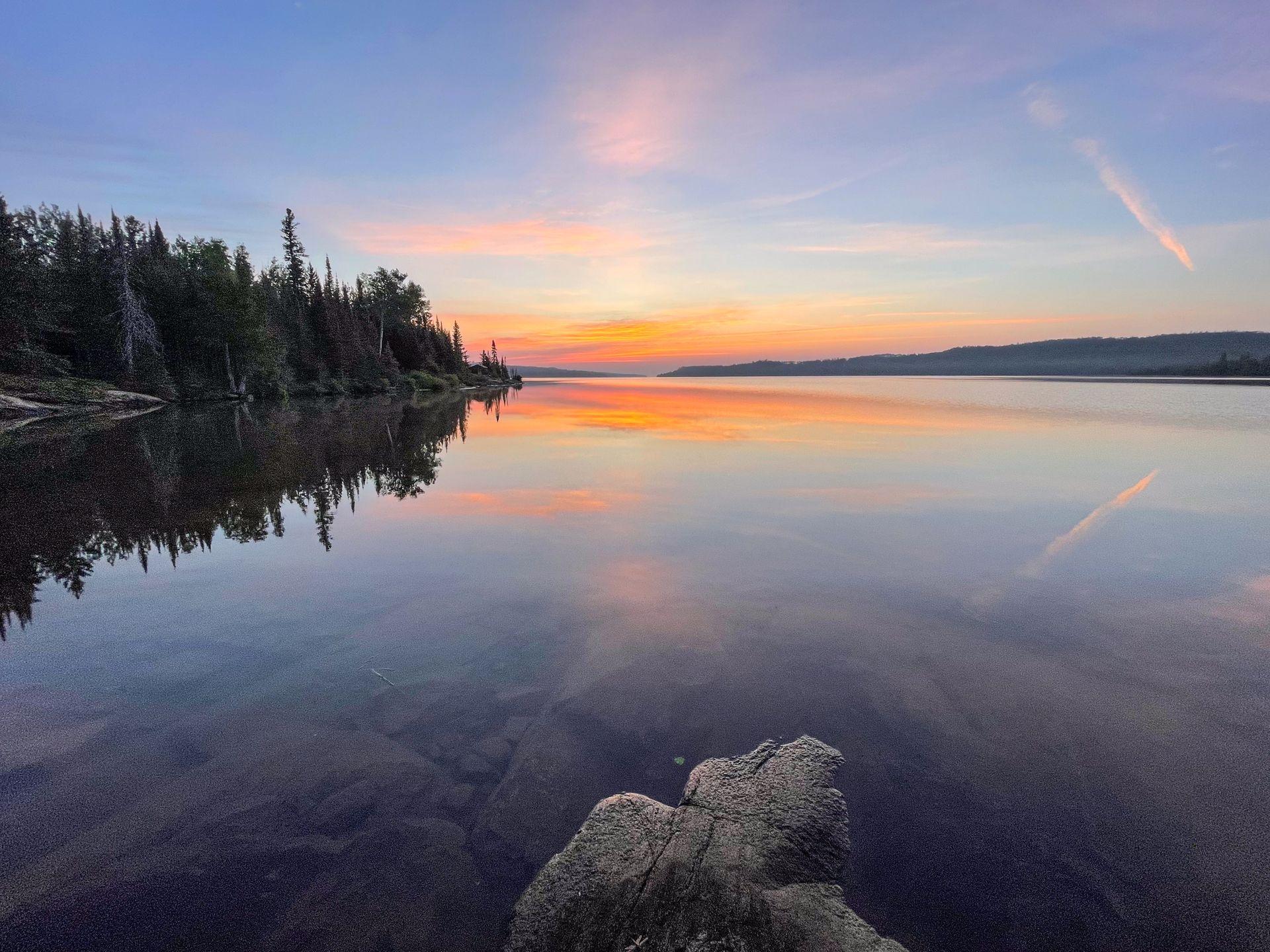 A colorful sky at sunrise seen from a campground in Isle Royale