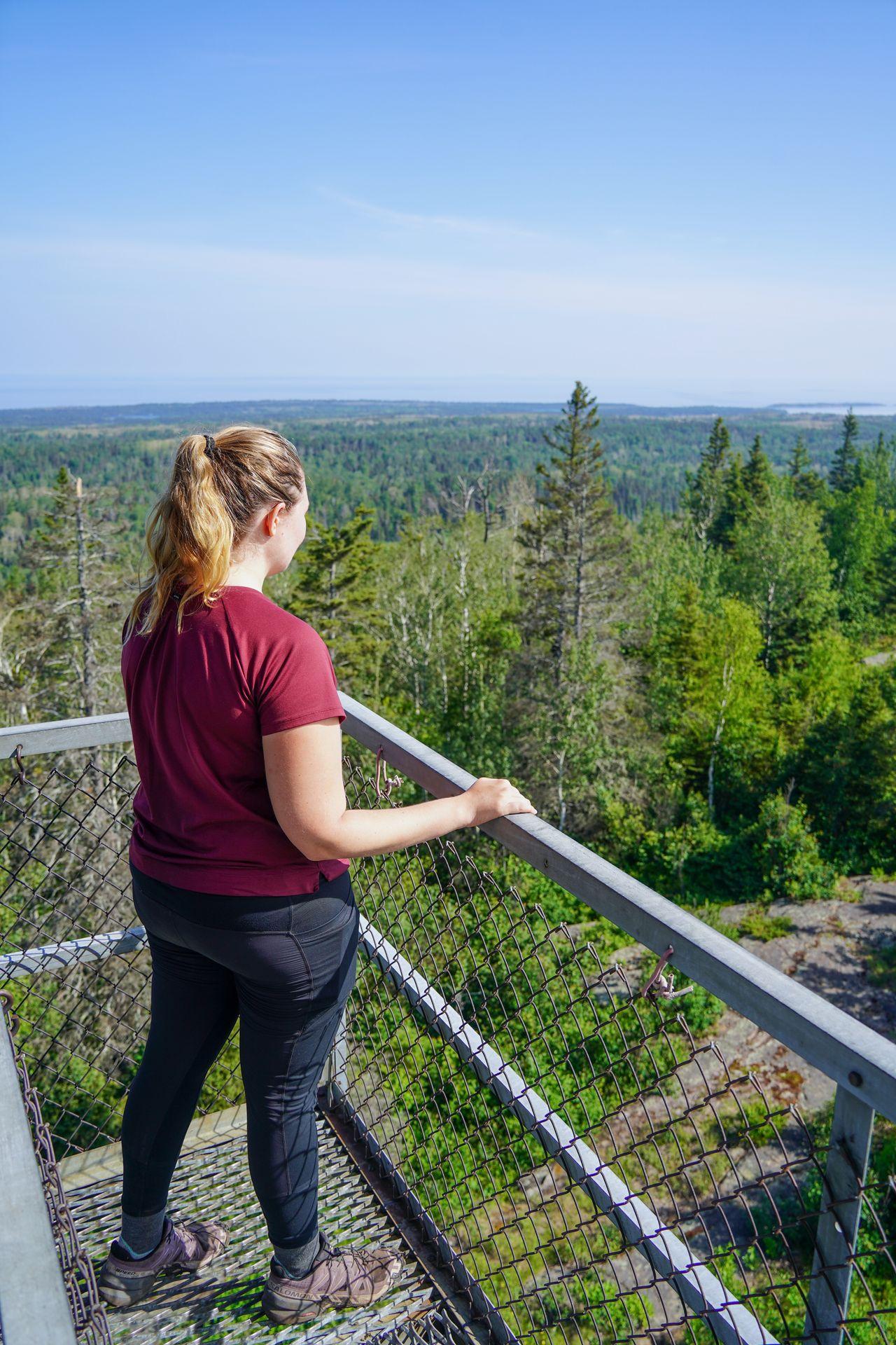 Lydia standing in the Mount Ojibway Tower and admiring the views