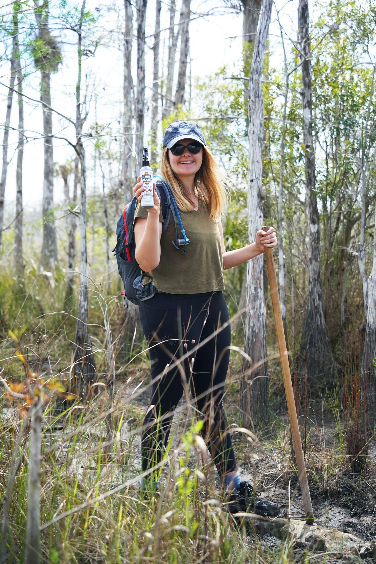 Lydia holding up a bottle of Ranger Ready in Big Cypress National Preserve.