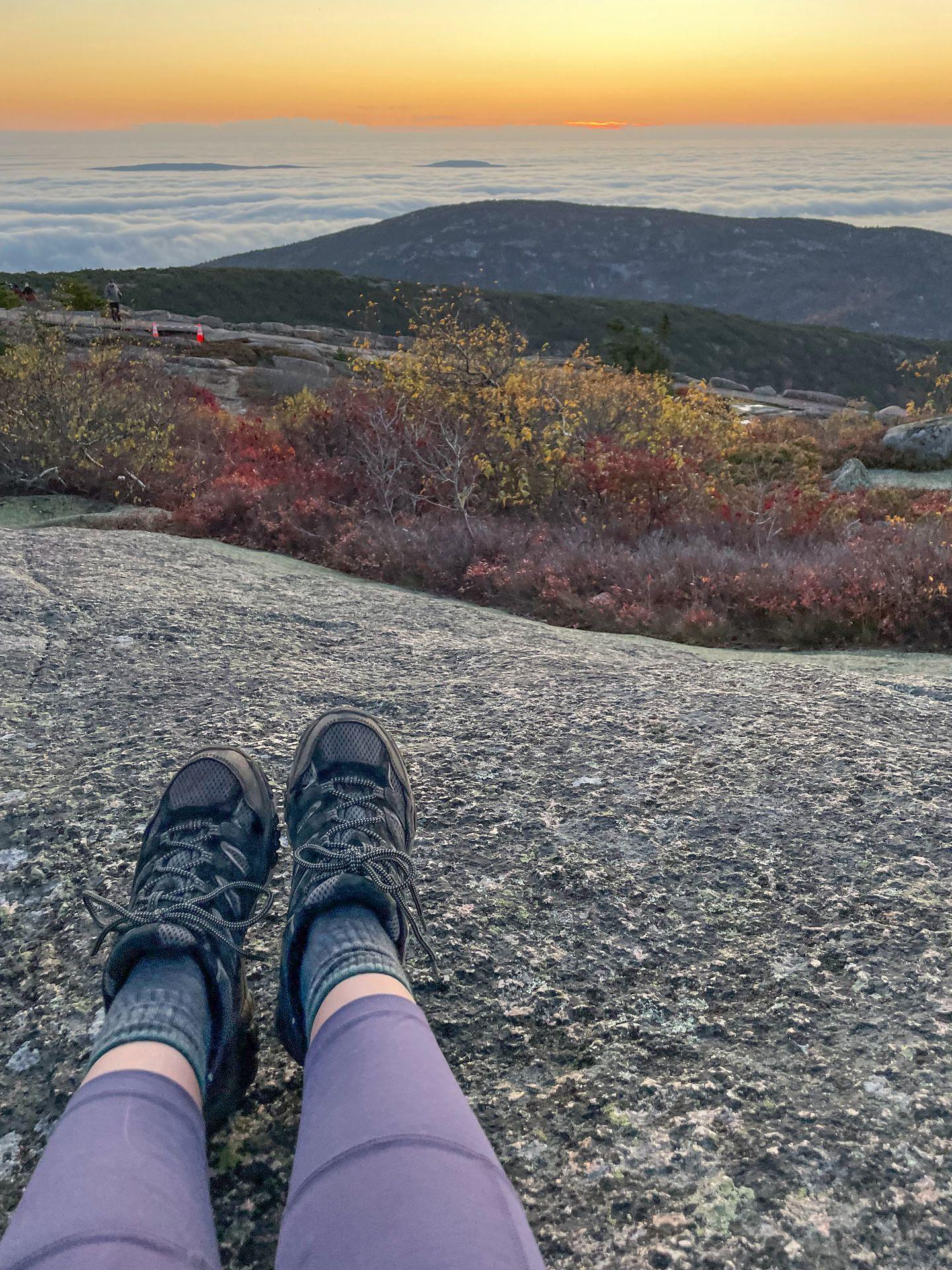A view of feet while on a hike in Maine.